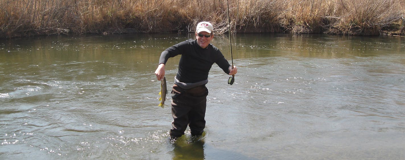 Jack Ohman, a Pulitzer Prize-winning political cartoonist who grew up in the Twin Cities, posed with a brown trout caught on the Owens River in California.