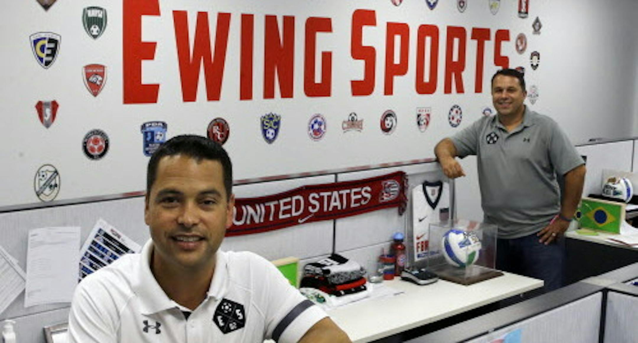 In this July 29, 2015 file photo, Chris Goodrich, left, and Les Korsos, stand in the offices of their company, Ewing Sports, that sells mostly soccer uniforms to school and other teams, in Ewing, N.J., Key employees at the company, Goodrich and Korsos bought Ewing Sports from their retiring bosses in July. They are part of a trend that is picking up momentum as sales of businesses increase. (AP Photo/Mel Evans)