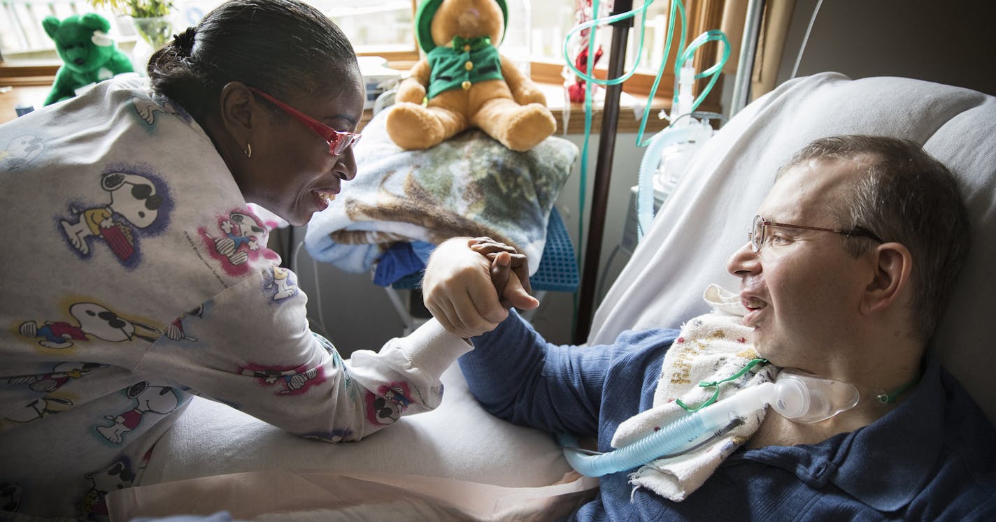 PCA Nora Clark playfully arm wrestles with Scott Semo.] LEILA NAVIDI &#xef; leila.navidi@startribune.com BACKGROUND INFORMATION: Scott Semo receives care from his PCA (personal care attendant) Nora Clark at his home in Roseville on Wednesday, March 22, 2017. Medicaid pays for 24 hour PCA care for Semo, who cannot walk, control his bladder or bowels, has ataxia and whose oxygen runs low as a result of a brain hemorrhage 16 years ago. Thousands of Minnesotans with disabilities would lose home and