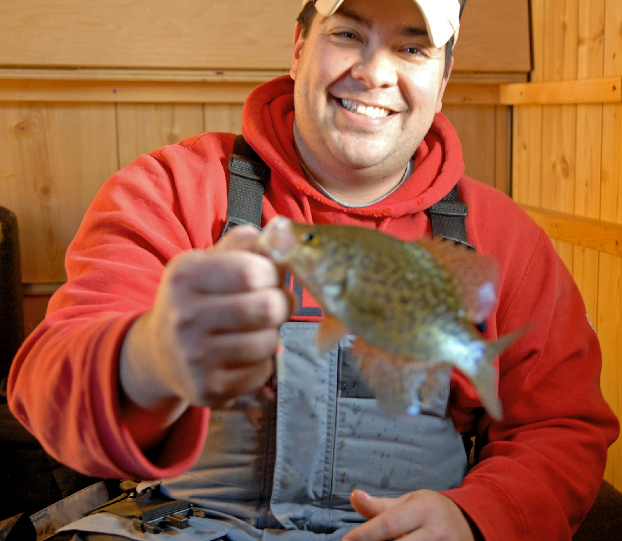 Dennis Anderson . 1/2009 ... Chris Mizuhata of Minnetrista shows off a small crappie that only briefly sees daylight before being released back into Lake Minnetonka. Fishing generally has been good on Minnetonka this winter.
