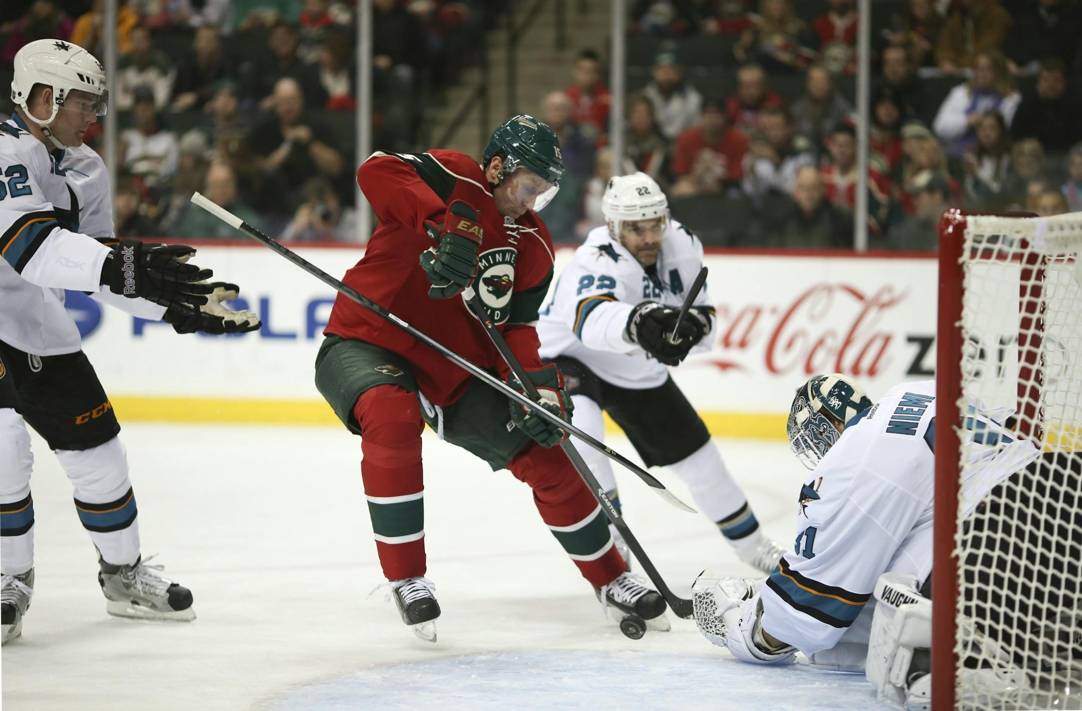 Dany Heatley (15) tried to stuff the puck past Sharks goalie San Jose Sharks goalie Antti Niemi (31) while San Jose defenseman Matt Irwin (52) looked for the handle on his stick in the first period earlier this month in St. Paul.