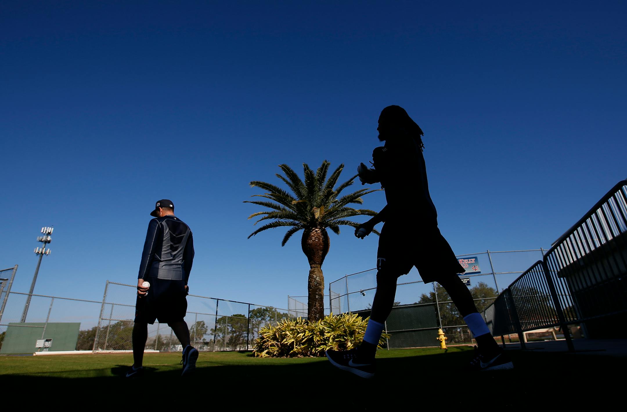 Twins pitchers Glen Perkins and Ervin Santana walked out to warm up at spring training in Fort Myers, Fla. Pitchers and catchers reported on Sunday.