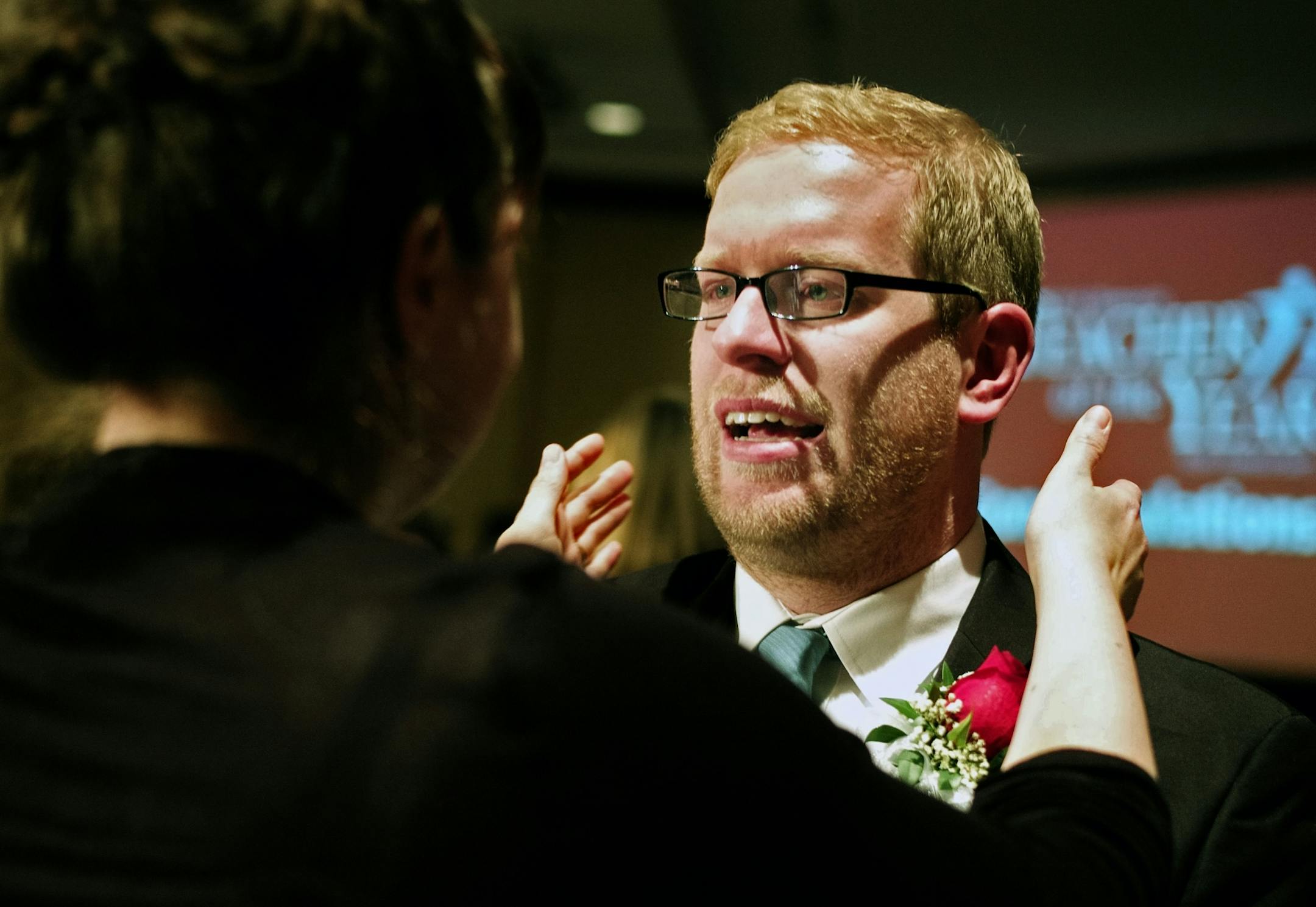 Thomas Rademacher, an English teacher at the FAIR School in the West Metro Education Program, celebrated his MInnesota Teacher of the year award with a hug from his wife Laura.