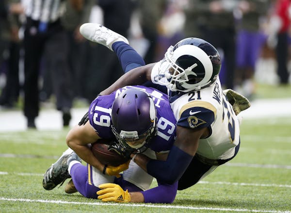 Minnesota Vikings wide receiver Adam Thielen (19) is tackled by Los Angeles Rams cornerback Kayvon Webster (21) after making a reception during the fi