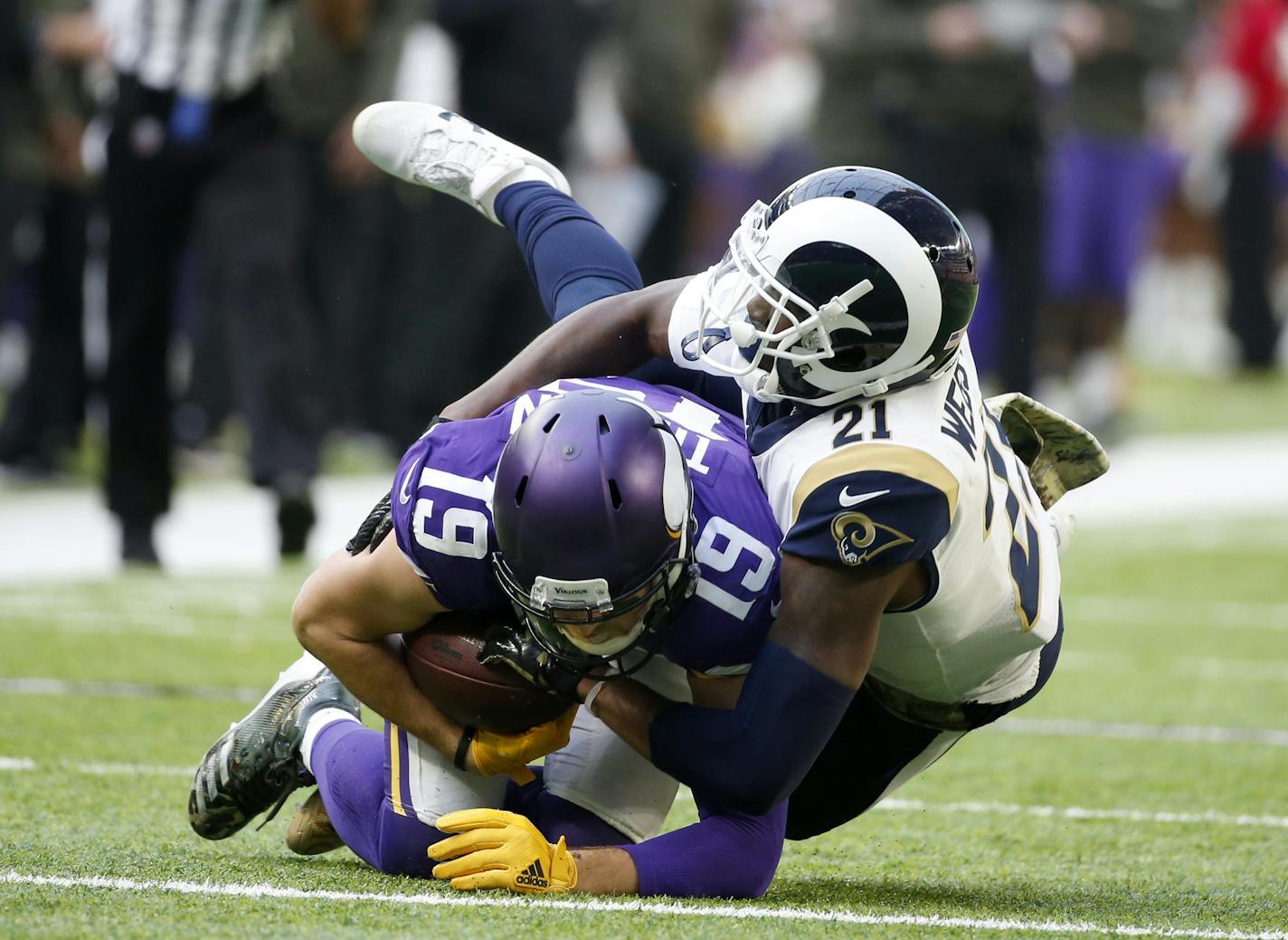 Minnesota Vikings wide receiver Adam Thielen (19) is tackled by Los Angeles Rams cornerback Kayvon Webster (21) after making a reception during the first half of an NFL football game, Sunday, Nov. 19, 2017, in Minneapolis. (AP Photo/Bruce Kluckhohn)