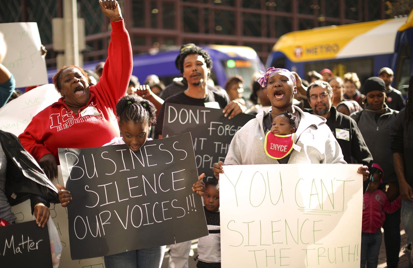 Demonstrators chanted "Black Workers Matter!" before they entered City Hall for a silent march through the halls Thursday afternoon. At right was Rosheeda Credit, who works at Target Field, joined in the chants with her daughter, Sha'rya Jenkins in a front carrier. ] JEFF WHEELER &#xef; jeff.wheeler@startribune.com Several groups banded together Thursday afternoon, October 15, 2015 to rally and protest Minneapolis Mayor Betsy Hodges decision not to pursue scheduling initiatives included in her W