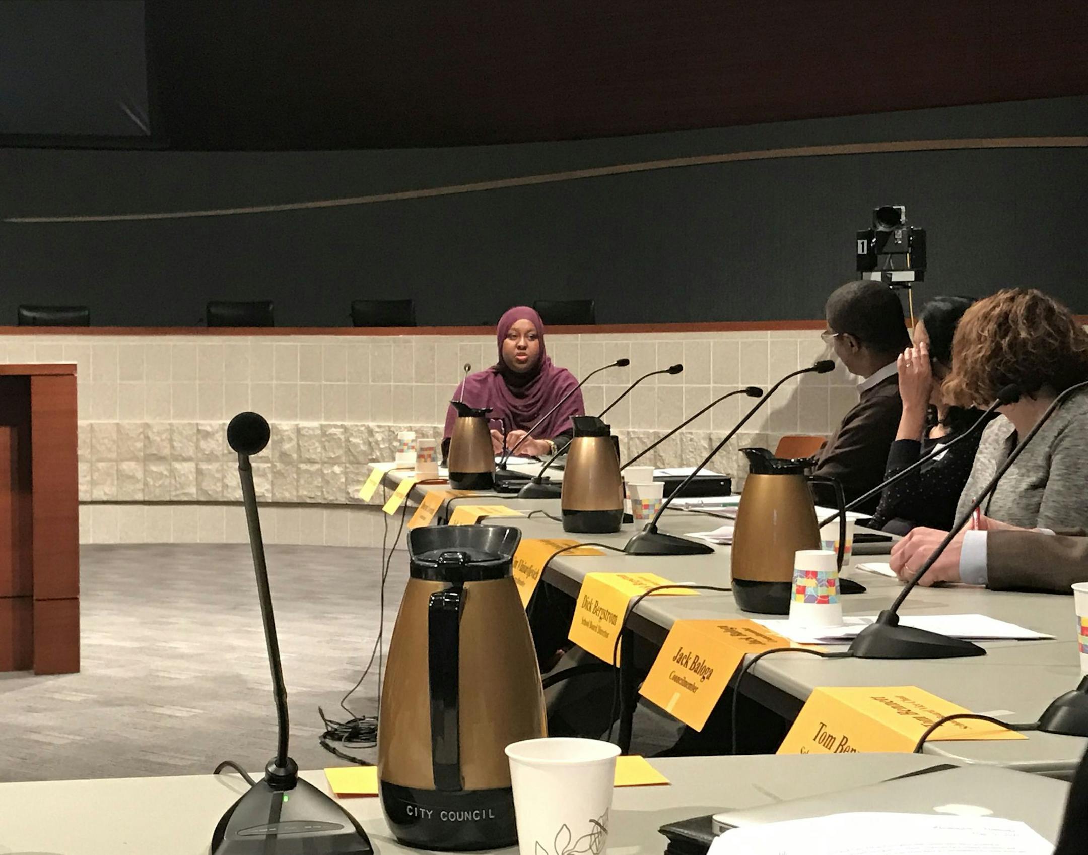 Hodan Hassan, left, addresses the Bloomington City Council and school board at Bloomington City Hall on Tuesday night. The administrations read a joint statement supporting the city's immigrant community.