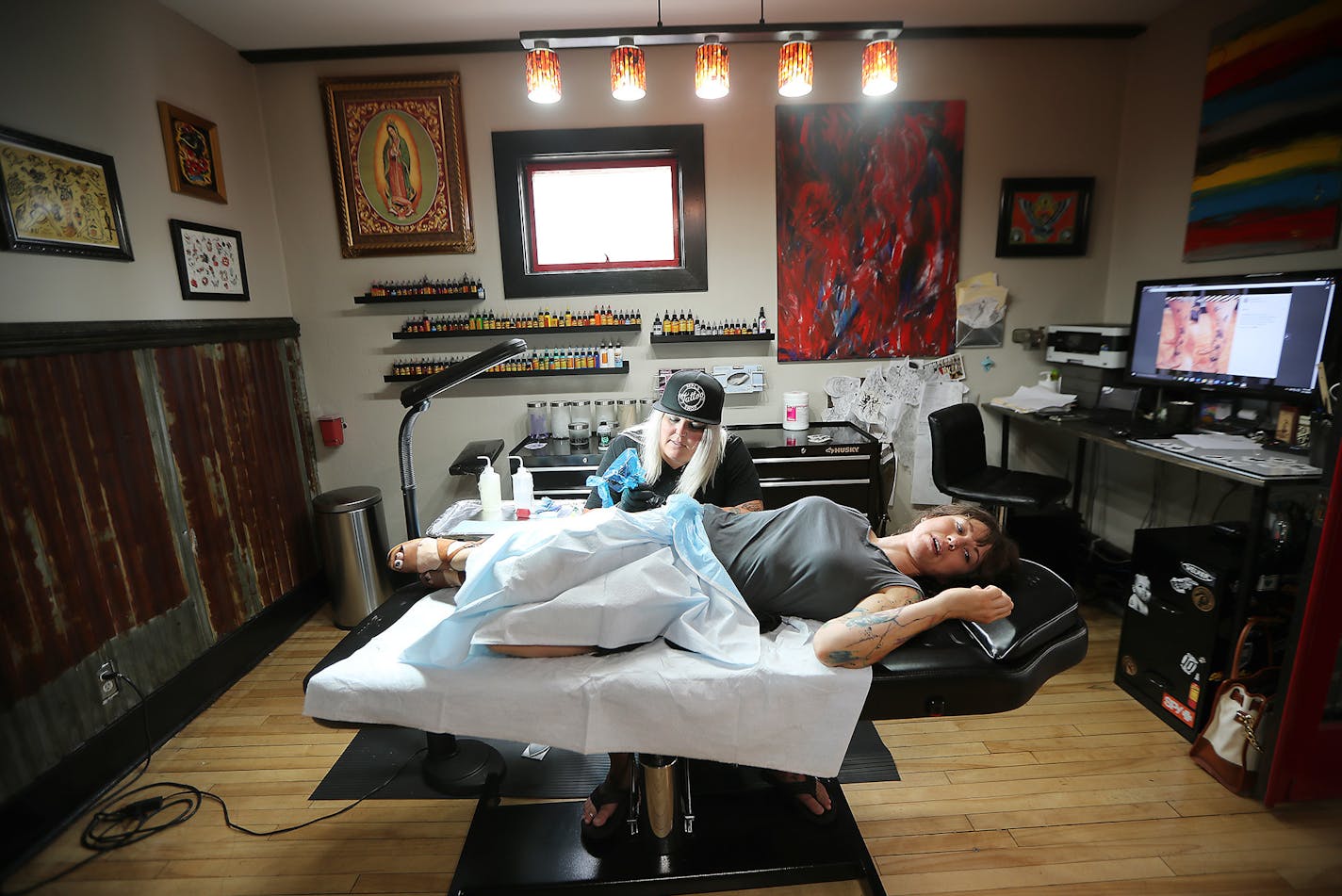 Tattoo artist and shop owner Nikki Time worked on client Abbey Harris, cq, as she got a tattoo at MPLS Tatoo Shop, Monday, July 11, 2016 in Minneapolis, MN. The number of female tattoo artists has soared since '90s, with women accounting for more than a third of artists in Minnesota. ] (ELIZABETH FLORES/STAR TRIBUNE) ELIZABETH FLORES &#x2022; eflores@startribune.com