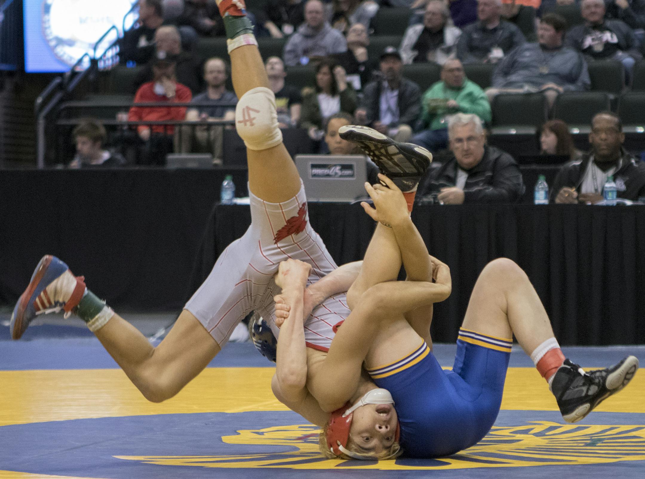 Mound Westonka's Aaron Cashman wound up upside down when being rolled by winner Patrick McKee of St. Michael Albertville in the Class 3A 106-pound final. McKee's brother, Mitchell, won the 138 crown. (Matt Blewett, Special to the Star Tribune)
