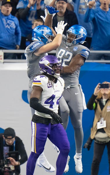 Minnesota Vikings safety Josh Metellus (44) walked off as Detroit Lions tight end Sam LaPorta (87) celebrated his first quarter touchdown with James M