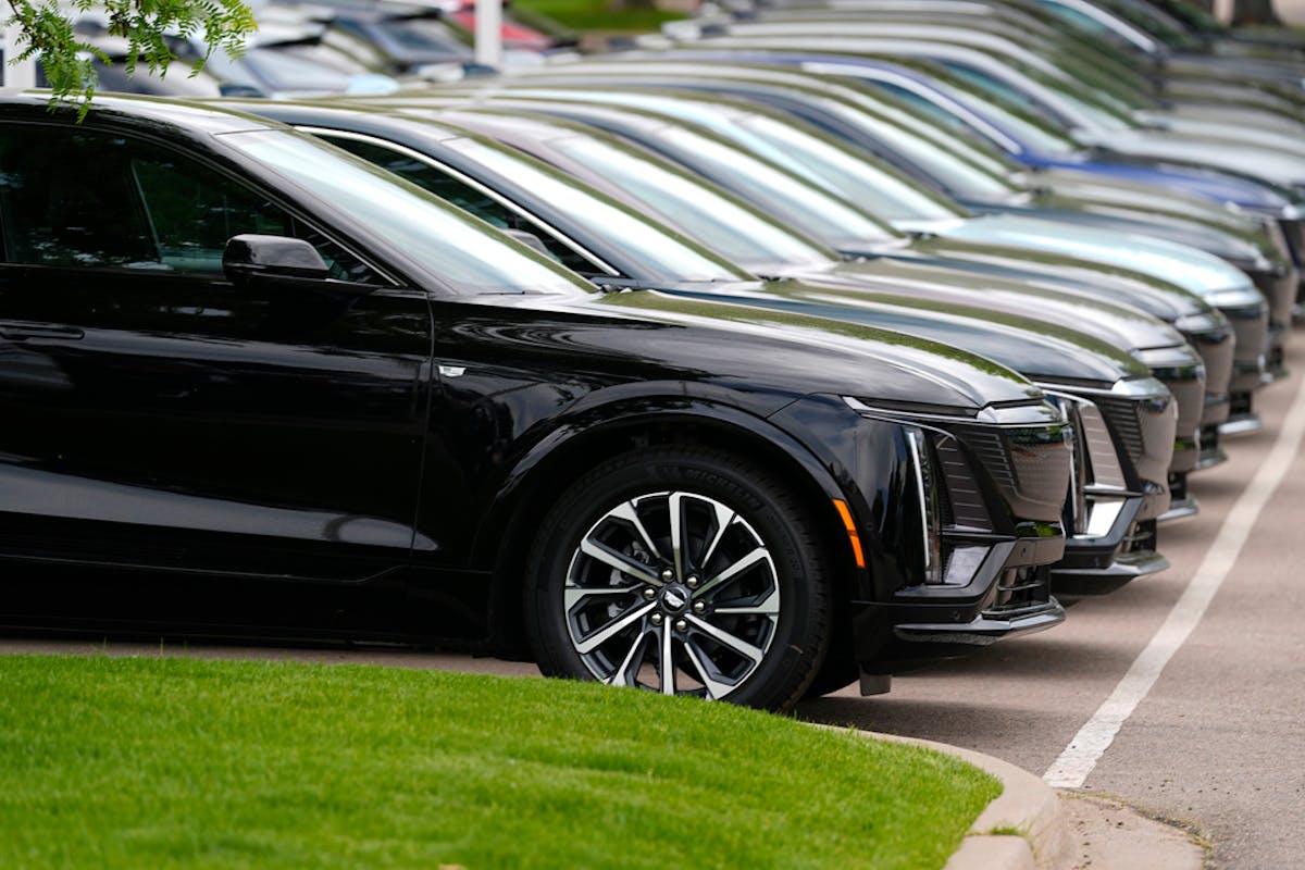 FILE - Vehicles sit in a row outside a dealership, June 2, 2024, in Lone Tree, Colo.