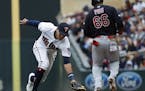 Minnesota Twins shortstop Ehire Adrianza (13) is late trying to get Cleveland Indians right fielder Yasiel Puig (66) on a ground ball in the third inn