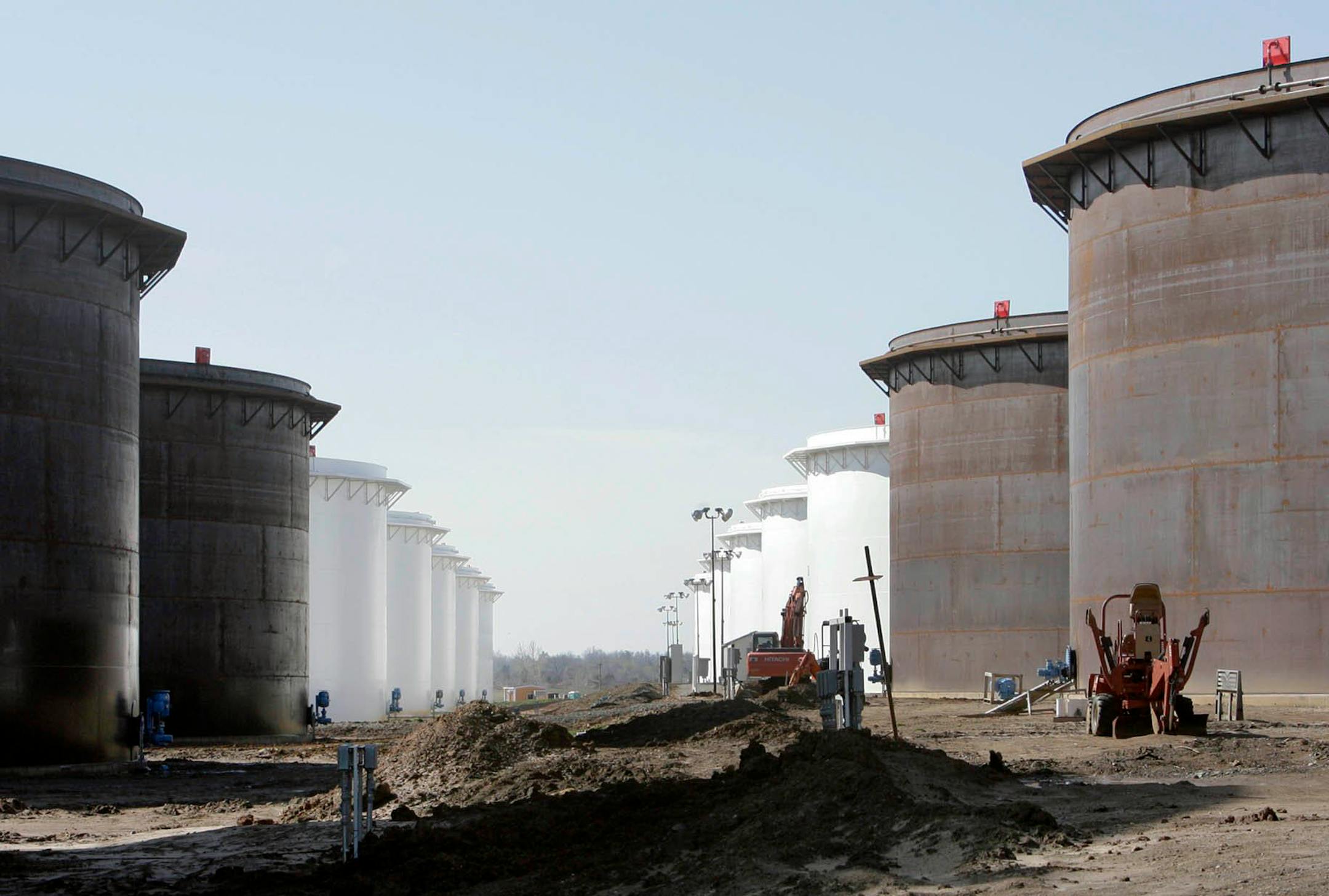This March 13, 2012 photo shows older and newly constructed 250,000 barrel capacity oil storage tanks at the SemCrude tank farm north of Cushing, Okla.