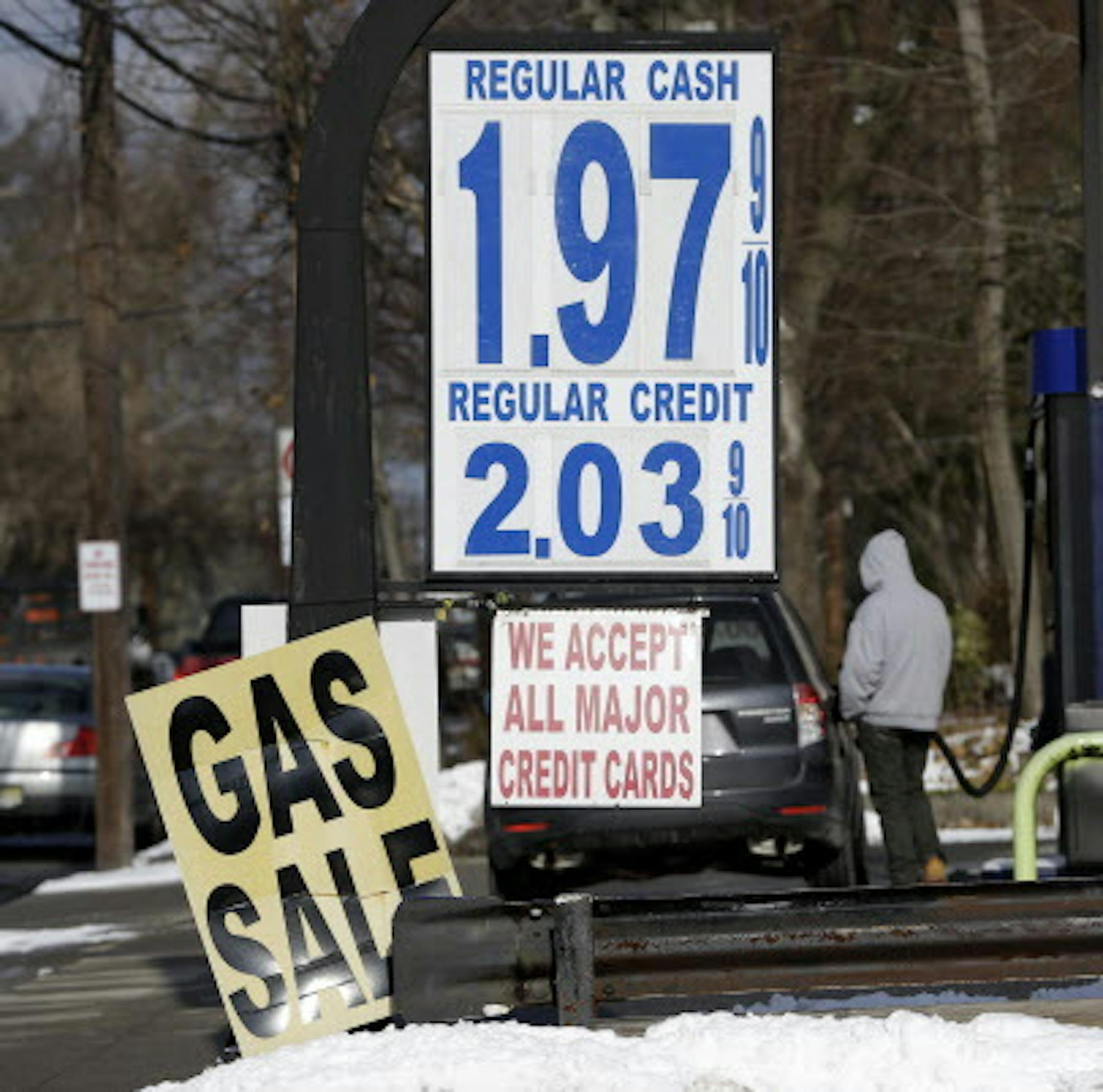 FILE - In this Jan. 9, 2015 file photo, gas prices were under two dollars a gallon are seen at a service station in Leonia, N.J. In 2015, natural gas has fallen even further than oil as U.S. drillers have been producing enormous amounts of gas and mild winter weather kept demand relatively low. (AP Photo/Seth Wenig, File)