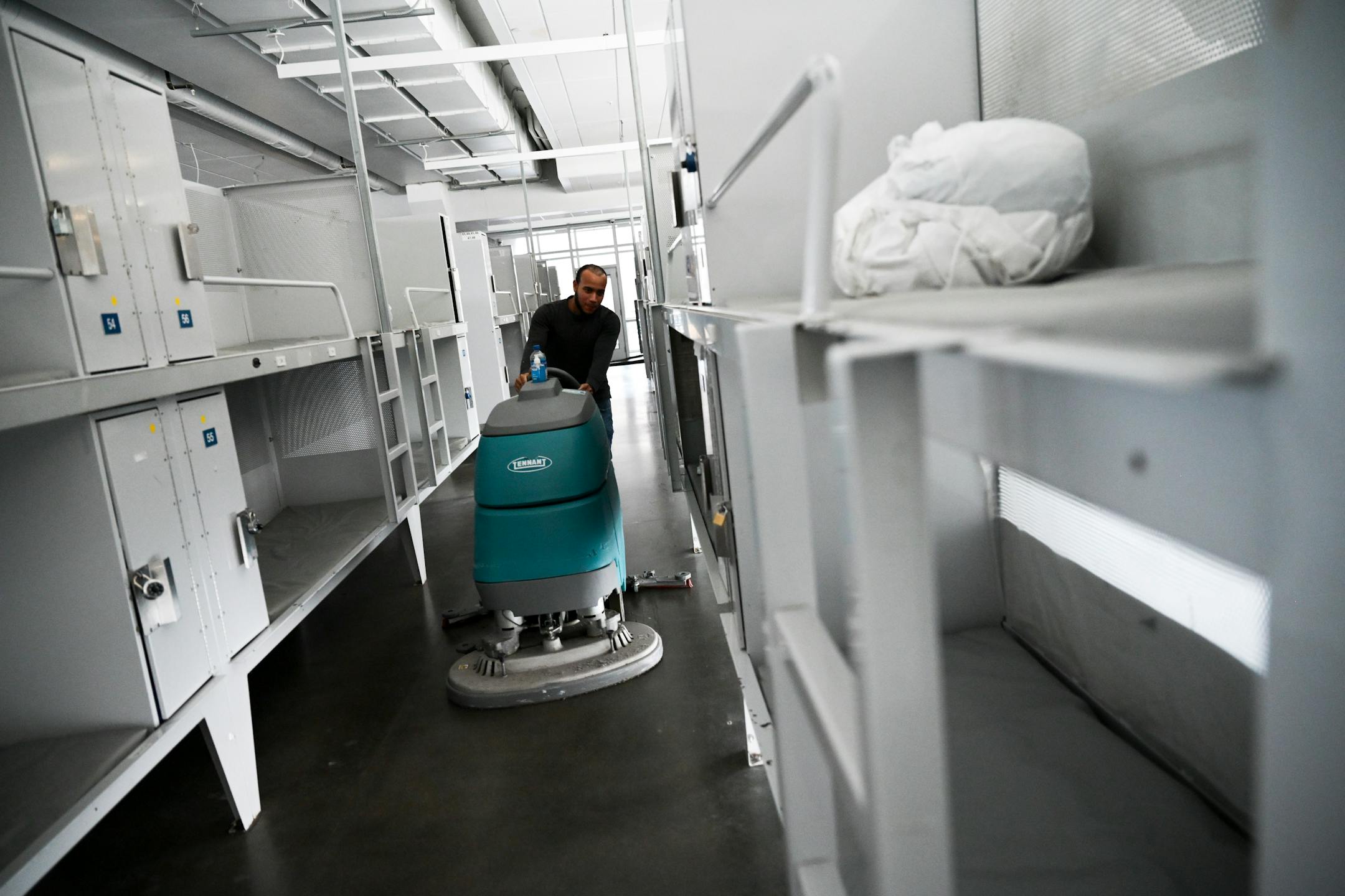 Ehury Luna Geraldino cleans the floors of the men's shelter at the Dorothy Day Opportunity Center in St. Paul on Friday.