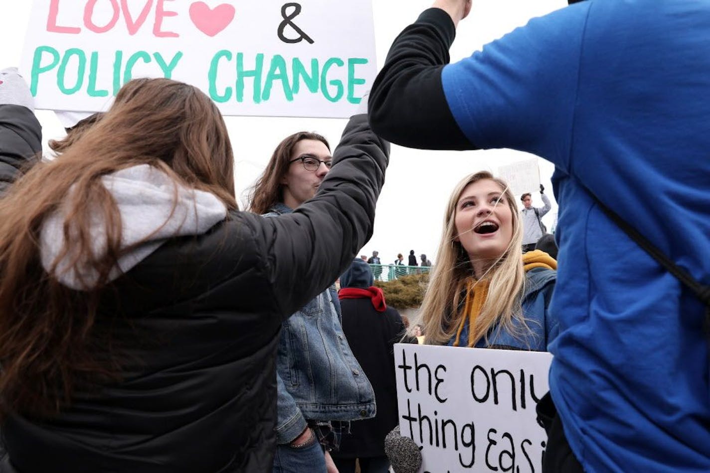 Students, including Grace Knutson, 18, of Woodbury, right, gathered at Harriet Island Regional Park in St. Paul before matching to the State Capitol protesting gun violence Saturday.