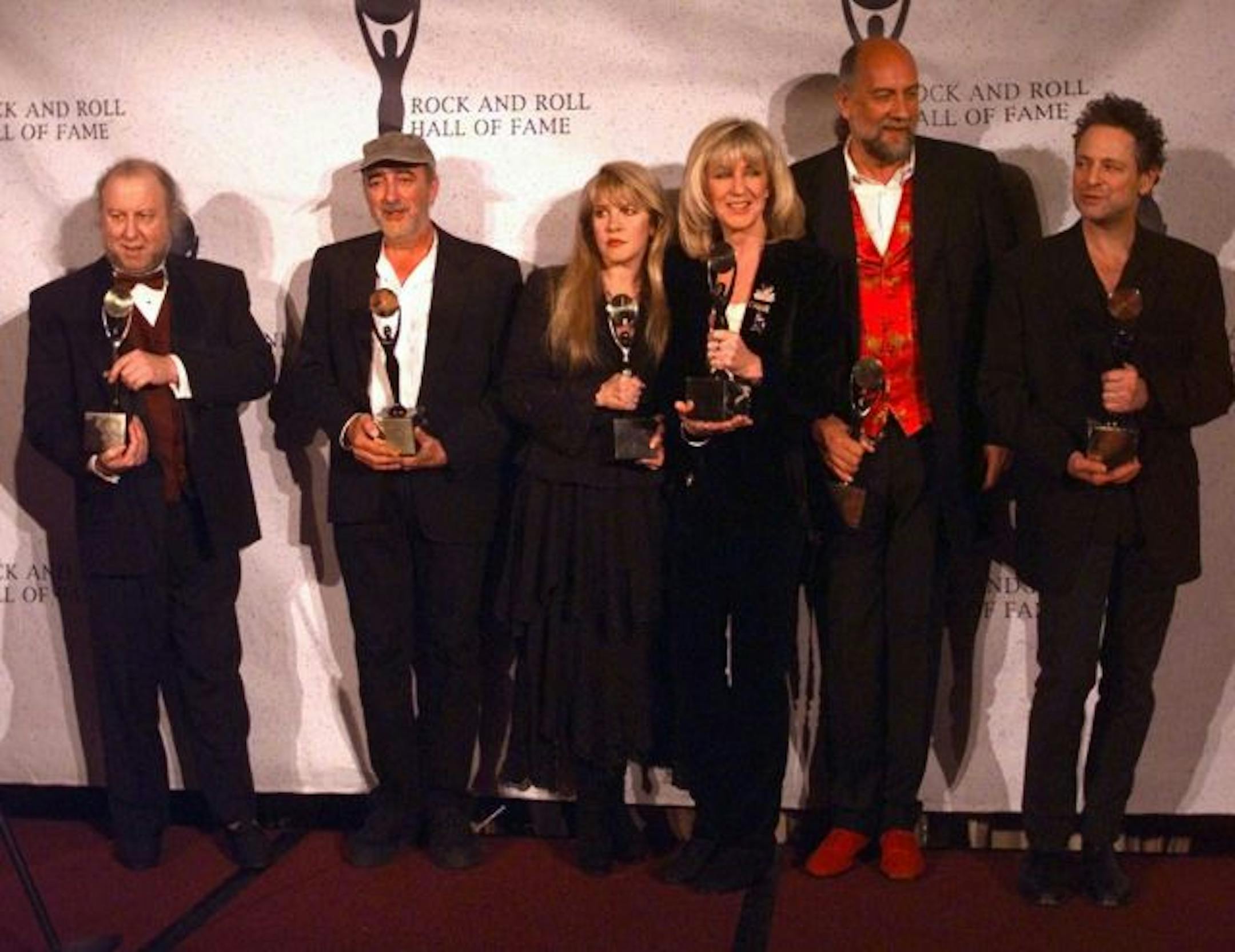 Members of Fleetwood Mac hold their awards after the group was inducted into the Rock and Roll Hall of Fame Monday, Jan. 12, 1998, in New York. From left, are: Peter Green; John McVie; Stevie Nicks; Christine McVie; Mick Fleetwood; and Lindsey Buckingham.