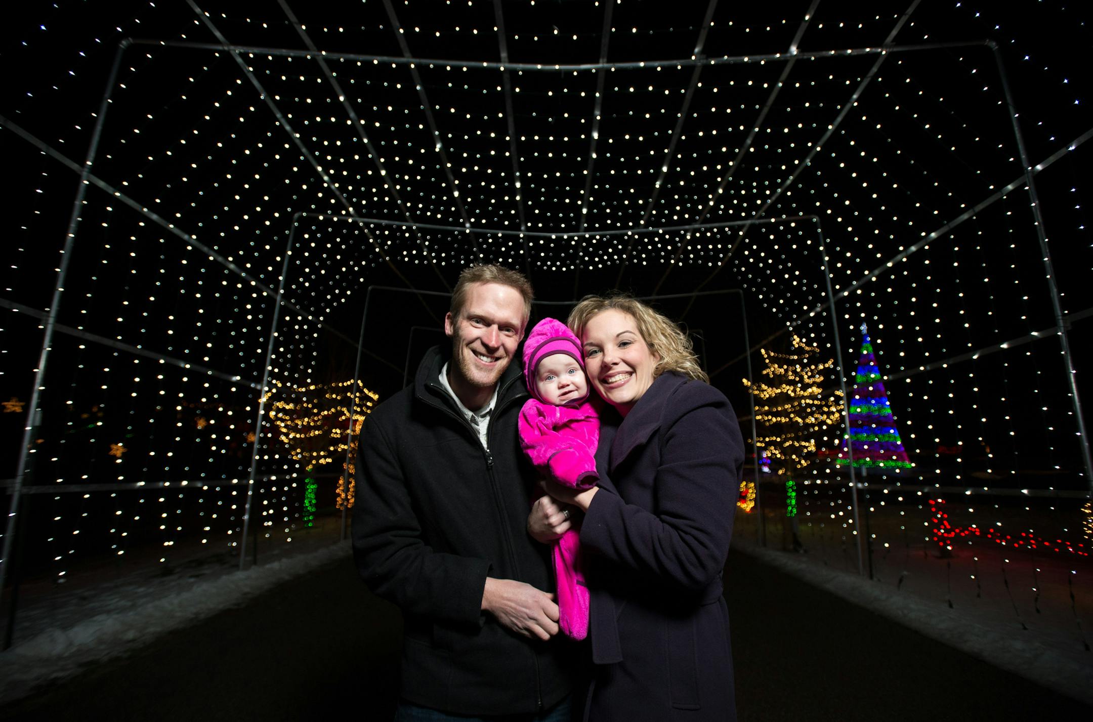Chad and Angela Koosman, and their 8-month-old daughter Sophia, are pictured in the light tunnel at the entrance to their Christmas light show, "Celebrate the Light of the World" on Thursday night. ] AARON LAVINSKY &#x2022; aaron.lavinsky@startribune.com Chad Koosman began ringing for the Salvation Army six years ago and quickly got competitive with the top donation-getter in town. But when Koosman put the red kettle among the growing light show in his front yard, there was no contest. In the pa