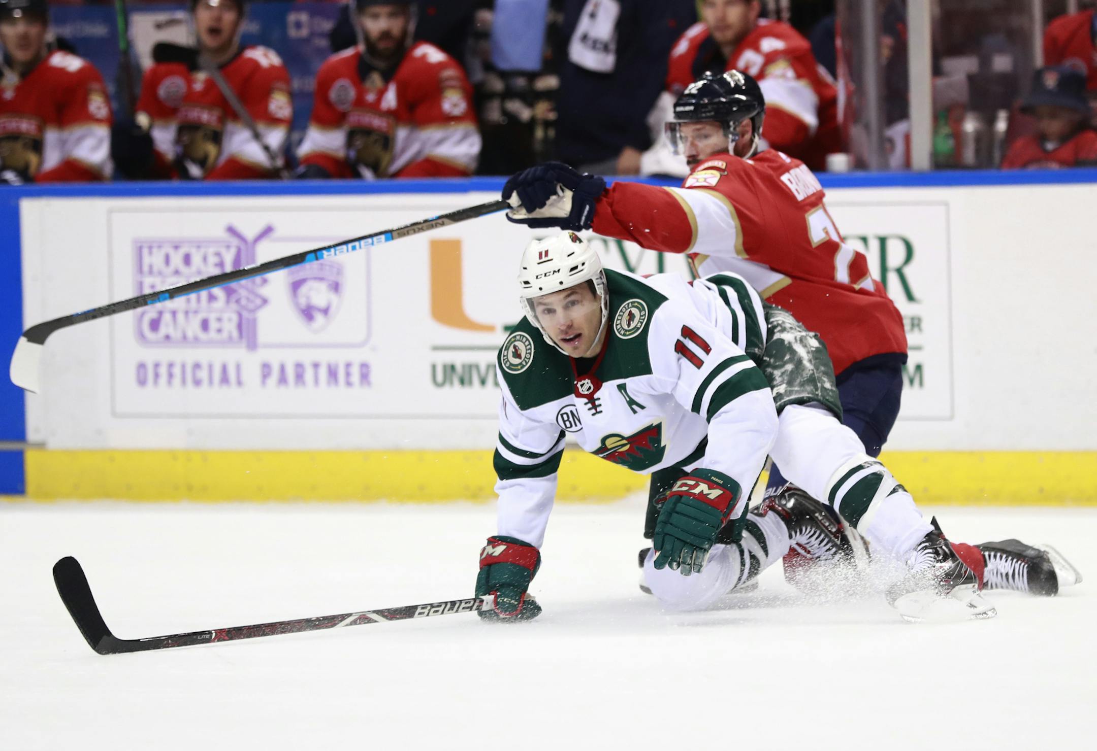 Minnesota Wild left wing Zach Parise (11) and Florida Panthers right wing Troy Brouwer battle for the puck during the first period of an NHL hockey game, Friday, March 8, 2019 in Sunrise, Fla. (AP Photo/Wilfredo Lee)