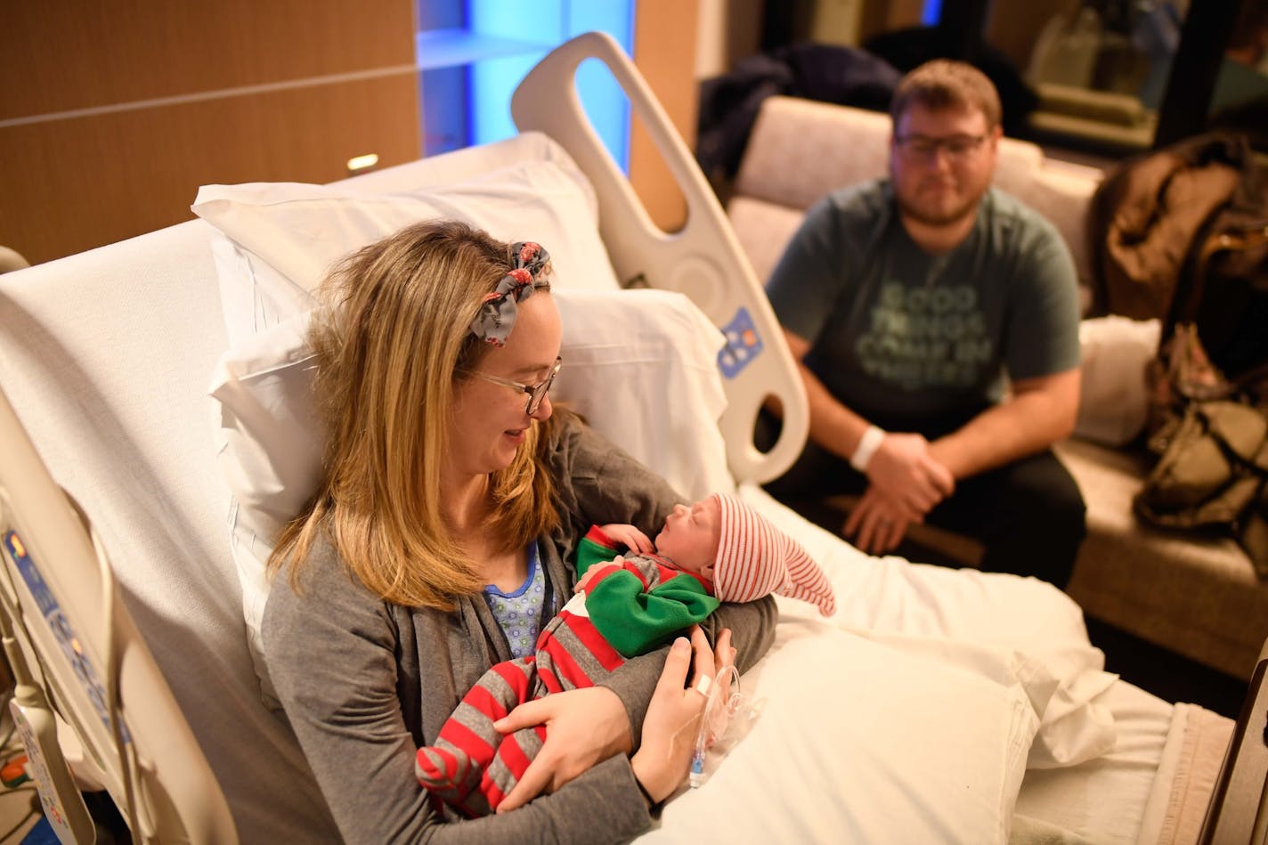 Hannah Lindeman held her newborn daughter, Poppy, in her hospital room Monday night. Sitting behind Hannah is her husband, Taylor, who delivered Poppy on the side of a road in Chisago City earlier Monday. ] AARON LAVINSKY &#xef; aaron.lavinsky@startribune.com Taylor Lindeman delivered his family's best Christmas present Monday along a frigid roadside in Chisago City shortly after his pregnant wife Hannah said he'd better call an ambulance. We photograph Taylor, Hannah and their newborn daughter,