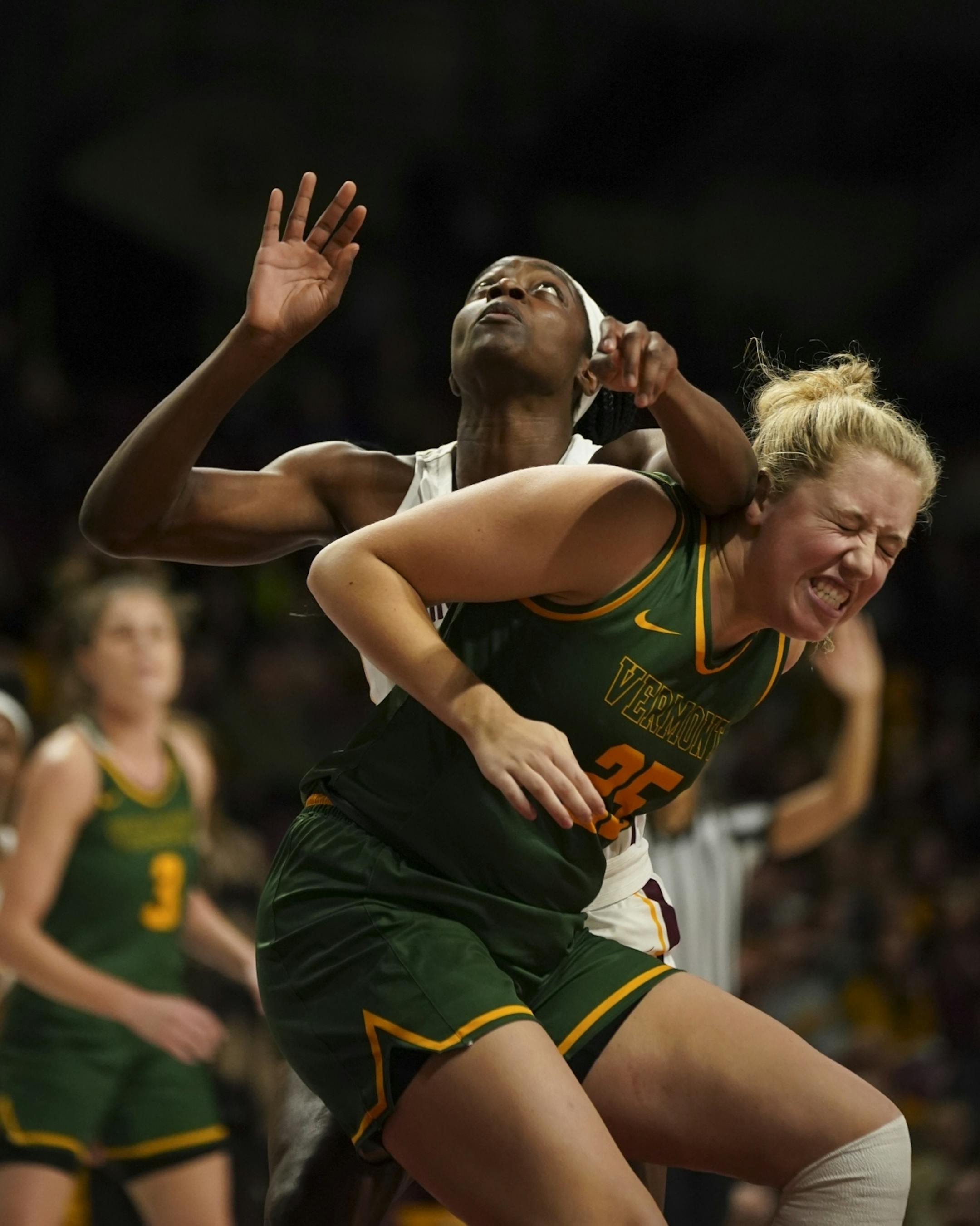 Vermont Catamounts forward Abby Settelmeyer (25) took an elbow to the ear while Minnesota Golden Gophers forward Kehinde Bello (20) watched for a second half rebound.