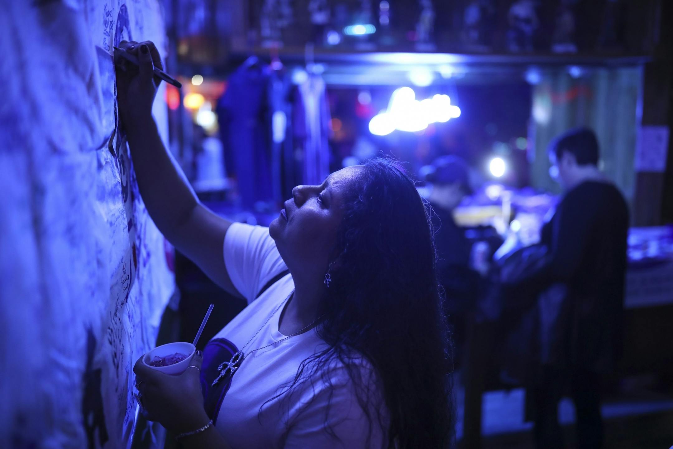 Rebecca Ortiz of Suisun, CA added her message to a memorial to Prince that was made by a fan in Japan and was on display at Lee's Liquor Lounge Wednesday night for the "Free Urself Dance Party."