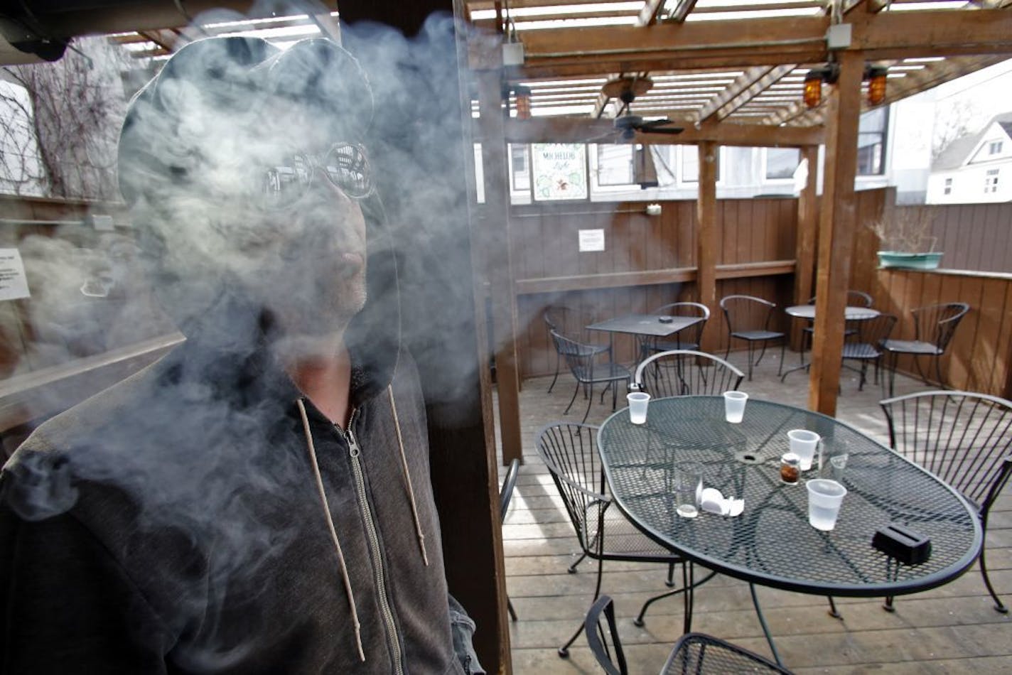 Peter Smyth smoked a cigarette on the patio of the CC Club in Minneapolis.