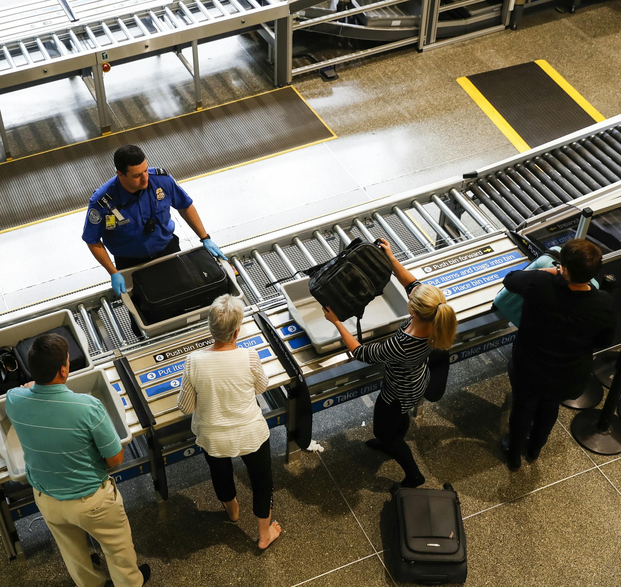 Passengers loaded their luggage into the new larger bins meant for all the luggage including suitcases at the South TSA checkpoint at Terminal 1 at the Minneapolis/St. Paul international airport on Tuesday, September 19, 2017, in Bloomington, Minn. Once passengers load their luggage they push it forward onto a moving rack that brings it through the security imaging. ] RENEE JONES SCHNEIDER • renee.jones@startribune.com