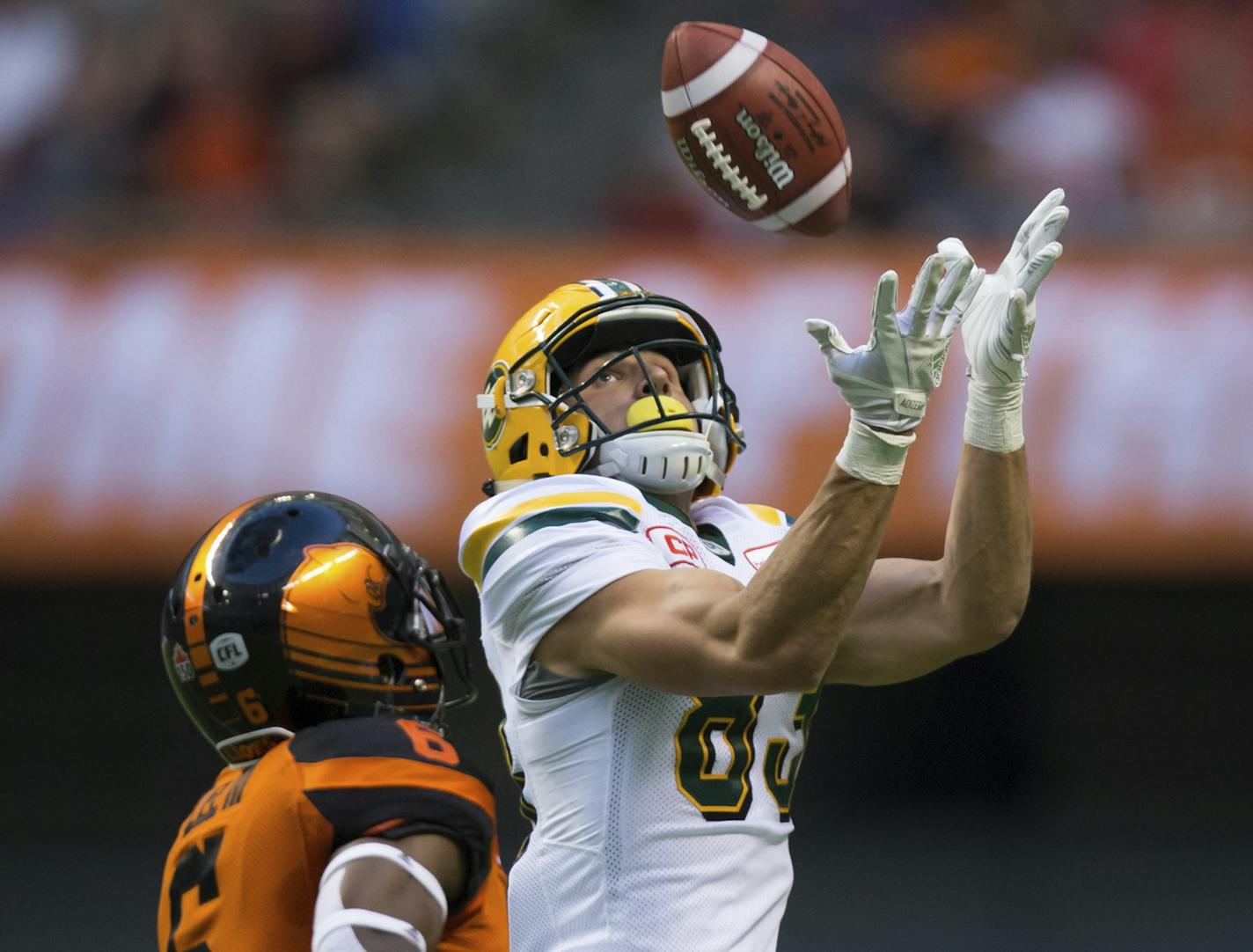 Edmonton Eskimos' Brandon Zylstra, right, makes a reception behind B.C. Lions' T.J. Lee during the first half of a Canadian Football League game Saturday, June 24, 2017, in Vancouver, British Columbia. (Darryl Dyck/The Canadian Press via AP)