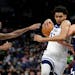 Minnesota Timberwolves center Karl-Anthony Towns (32) drives on Denver Nuggets center Nikola Jokic (15) and forward Will Barton during the first half 