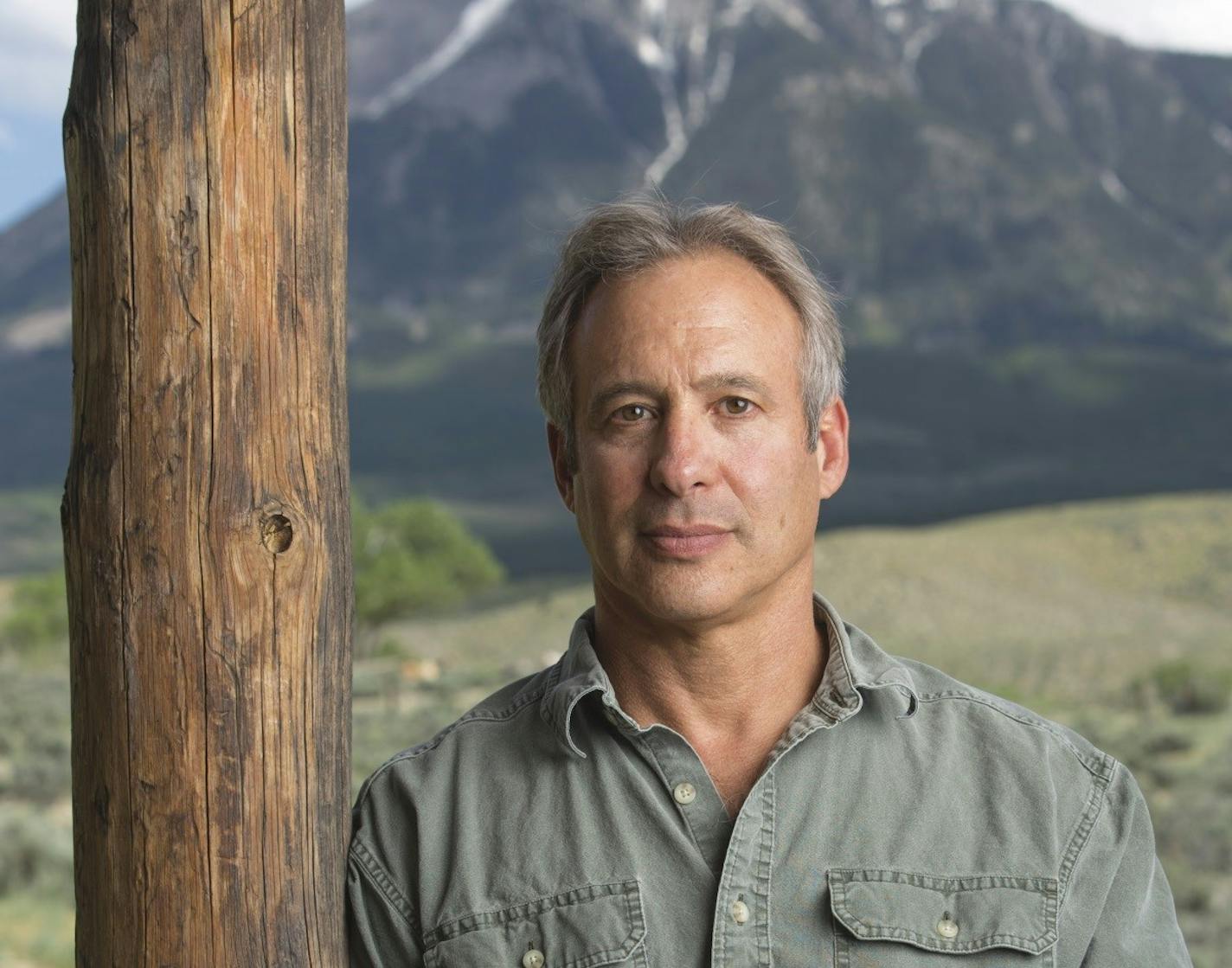 photo of author Peter Heller, with mountains in background