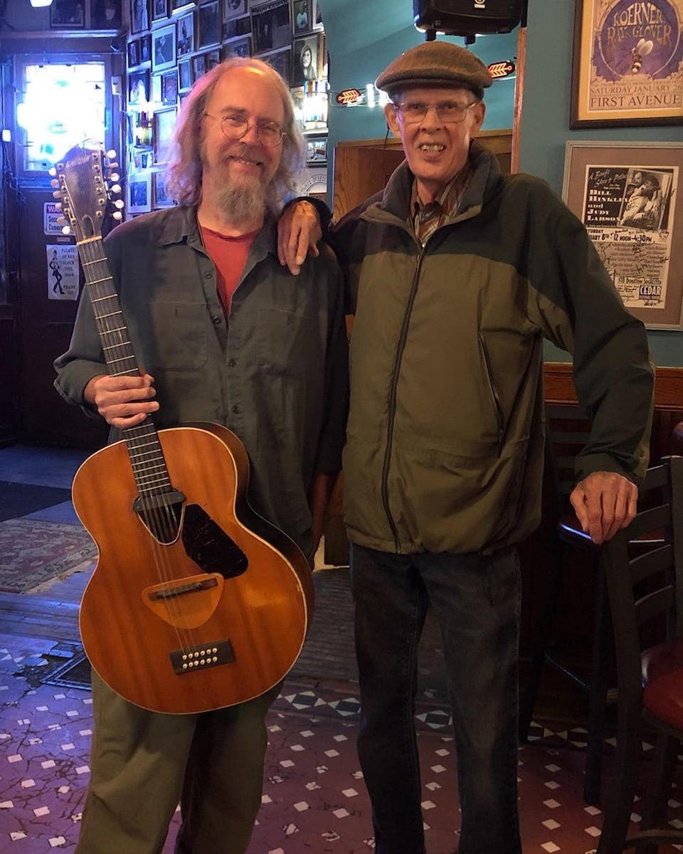Charlie Parr, left, is the proud new owner and “overprotective guardian” of a Gretsch guitar given to him by Spider John Koerner last week at Palm