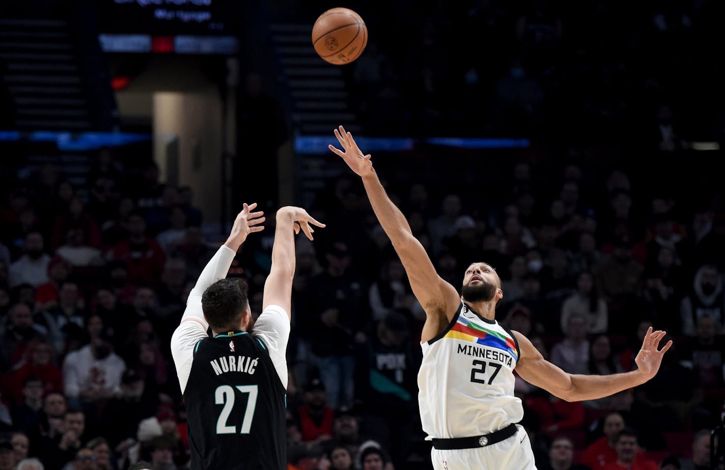 Portland Trail Blazers center Jusuf Nurkic, left, hits a shot over Timberwolves center Rudy Gobert during the first half