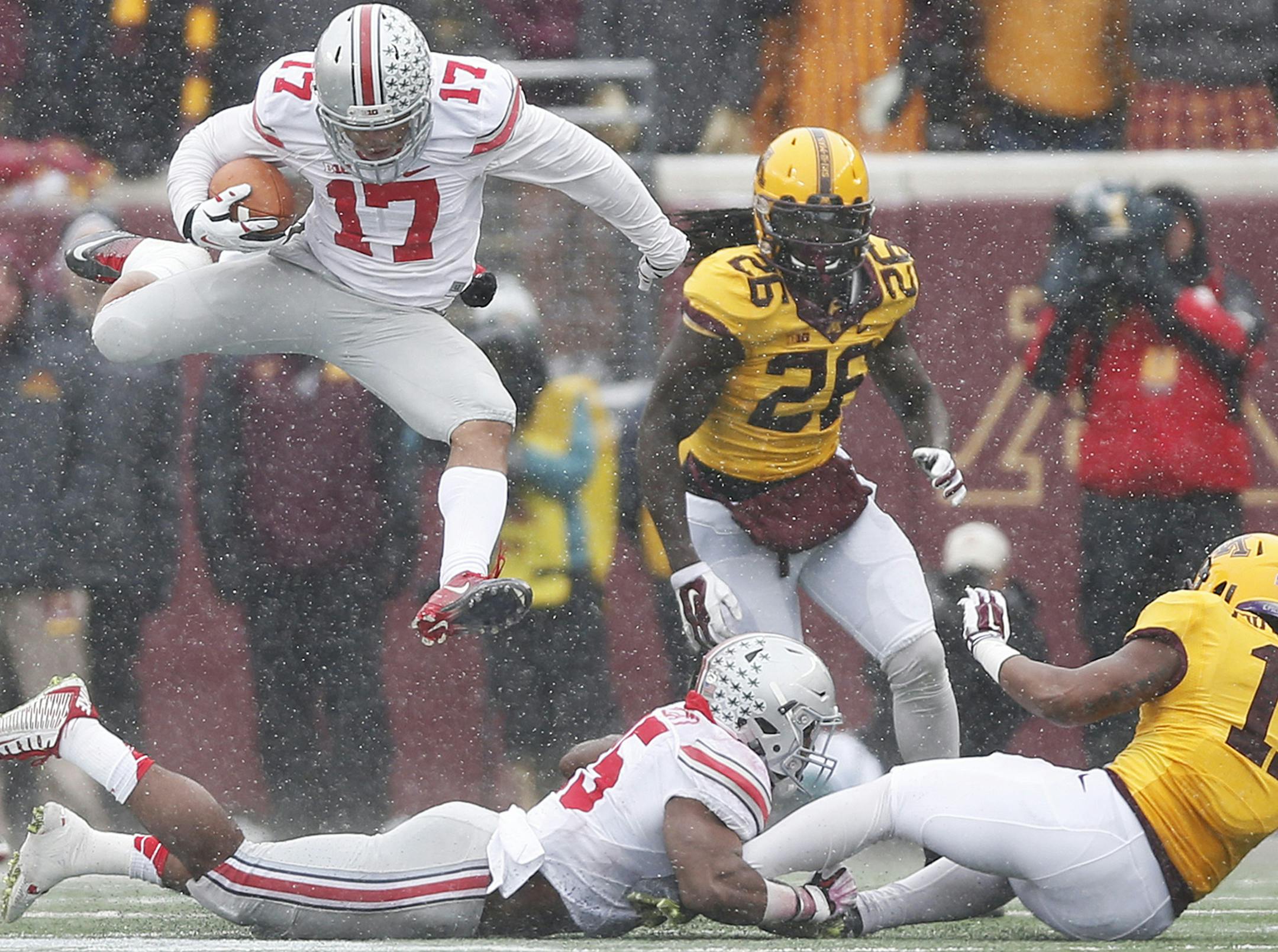 Ohio State Buckeyes running back Jalin Marshall (17) leaps through the air as he runs the ball in the second quarter at TCF Bank Stadium on Nov. 15, 2014 in Minneapolis. The Buckeyes won 31-24. (Eamon Queeney/Columbus Dispatch/MCT) ORG XMIT: 1160109