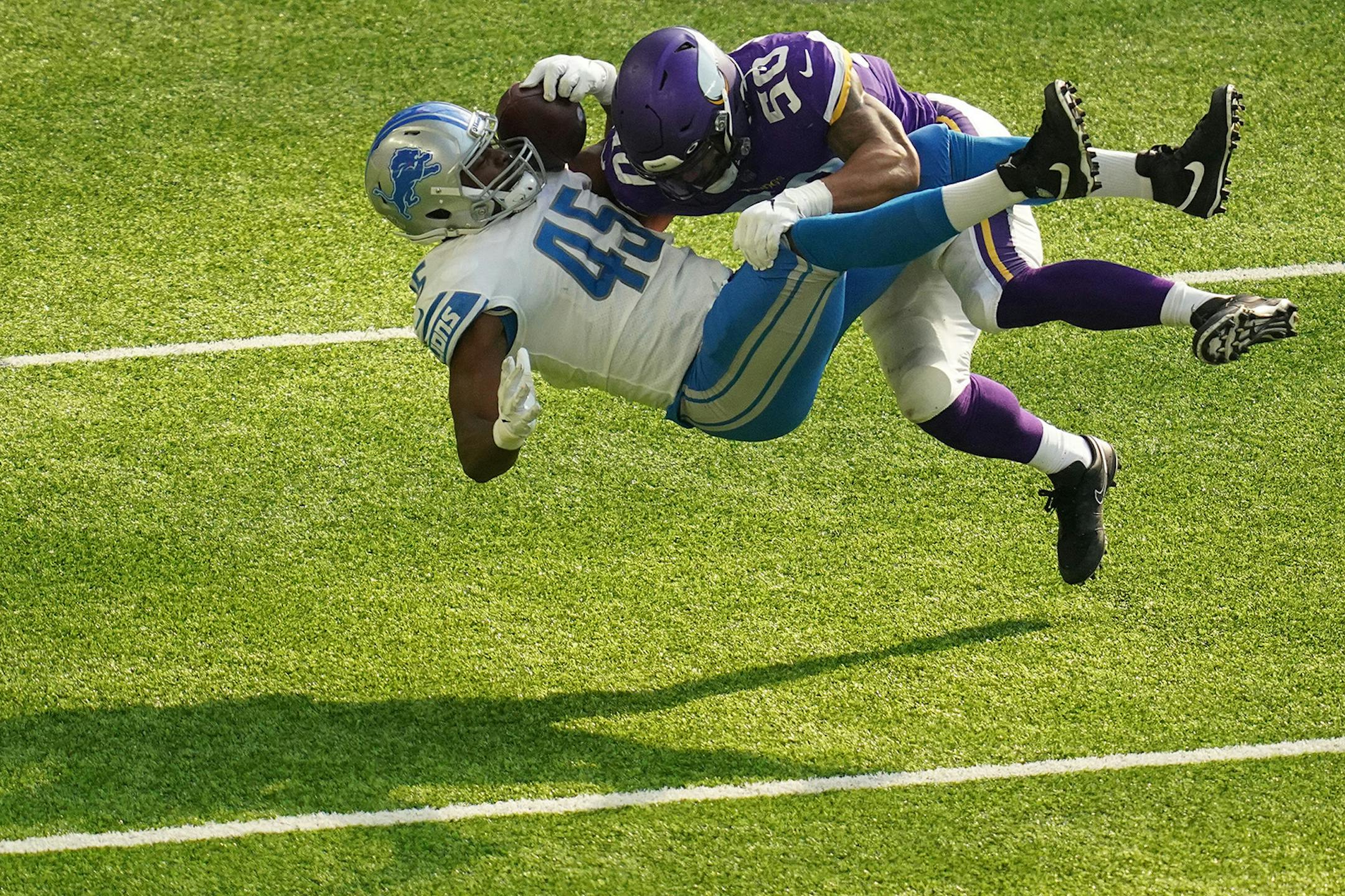 Detroit Lions fullback Jason Cabinda (45) was tackled by Minnesota Vikings outside linebacker Eric Wilson (50) in the second quarter.