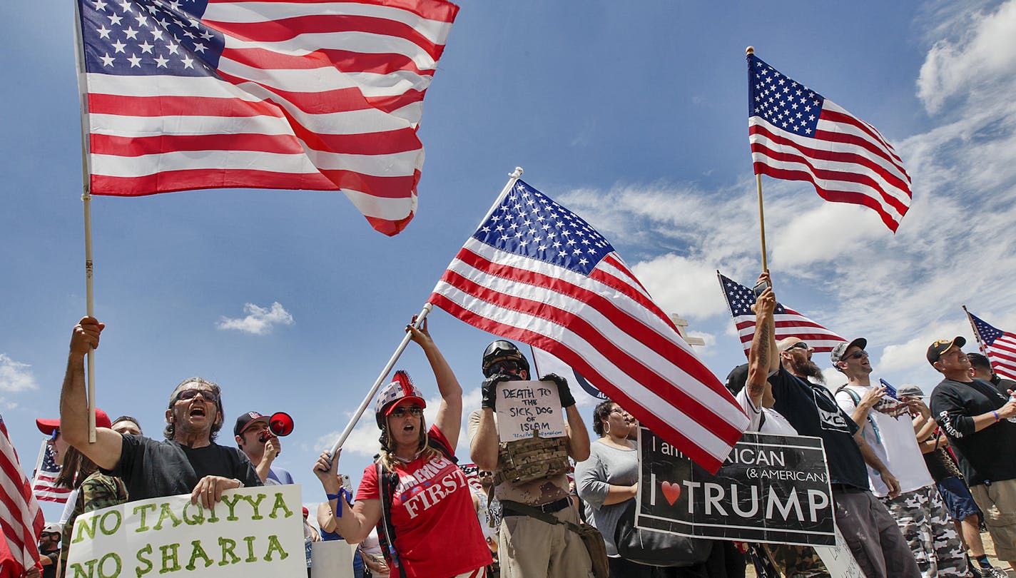 Anti-Sharia protesters at the site of the San Bernardino, Calif., terrorist attack as part of a nationwide "March Against Sharia"&#xf9; event sponsored by the conservative group Act for America on Saturday, June 10, 2017. Protesters chanted "USA!"&#xf9; and waved signs, including one that said "Islam is not American," near the county's Inland Regional Center, where a Pakistani American couple fatally shot 14 people in 2015. (Irfan Khan/Los Angeles Times/TNS) ORG XMIT: 1203900 ORG XMIT: MIN170610