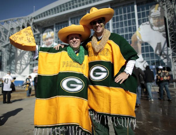 Green Bay Packers fan Garland Green (L) from Stetsonville, Wisconsin and Jeff Glessing, from Lake Geneva, pose outside Cowboys Stadium prior to the NF