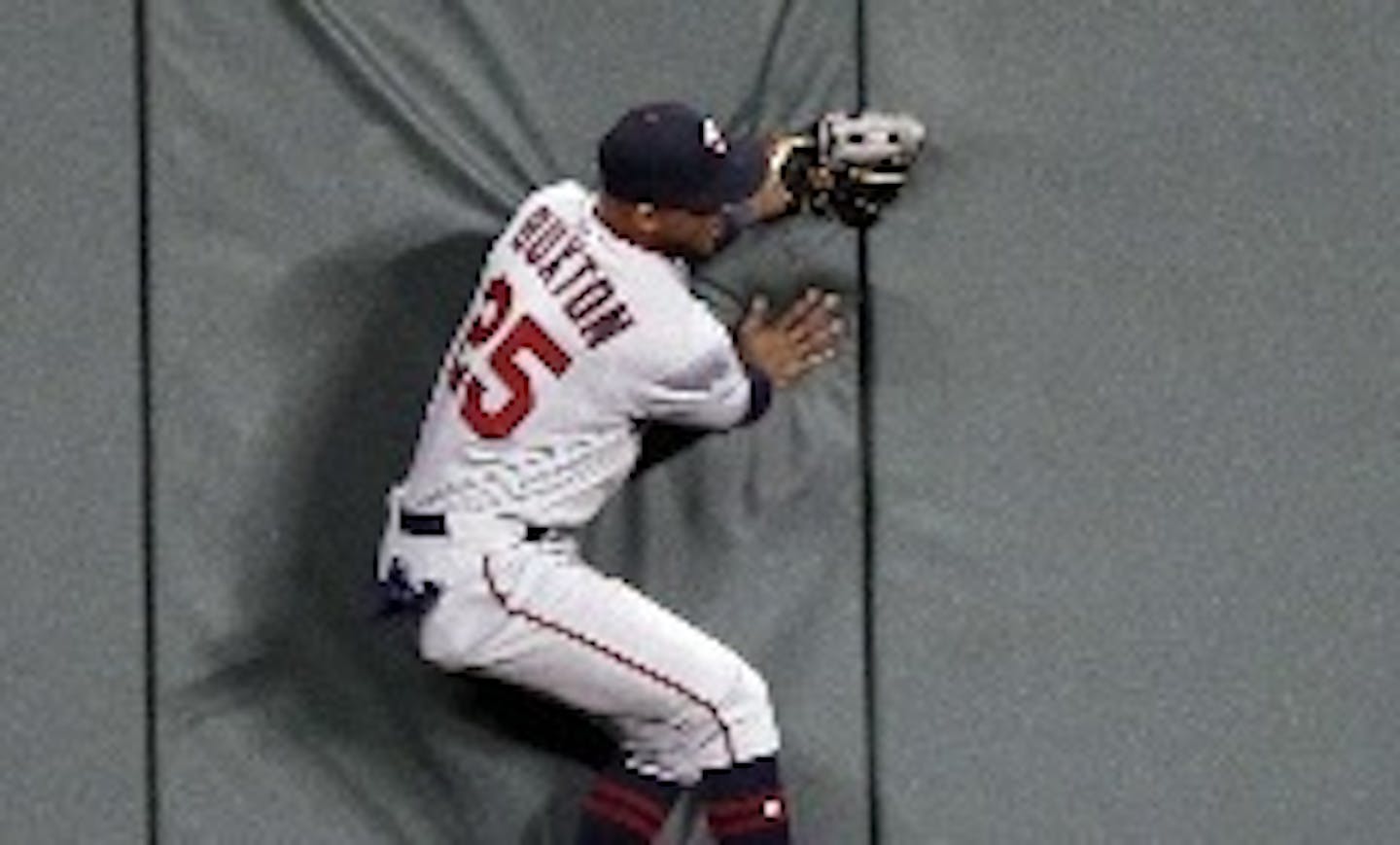 Twins center fielder Byron Buxton collided with the center field wall while trying to catch the Royals' Adalberto Mondesi's deep fly ball in the eighth inning and suffered a bruise on his lower back.