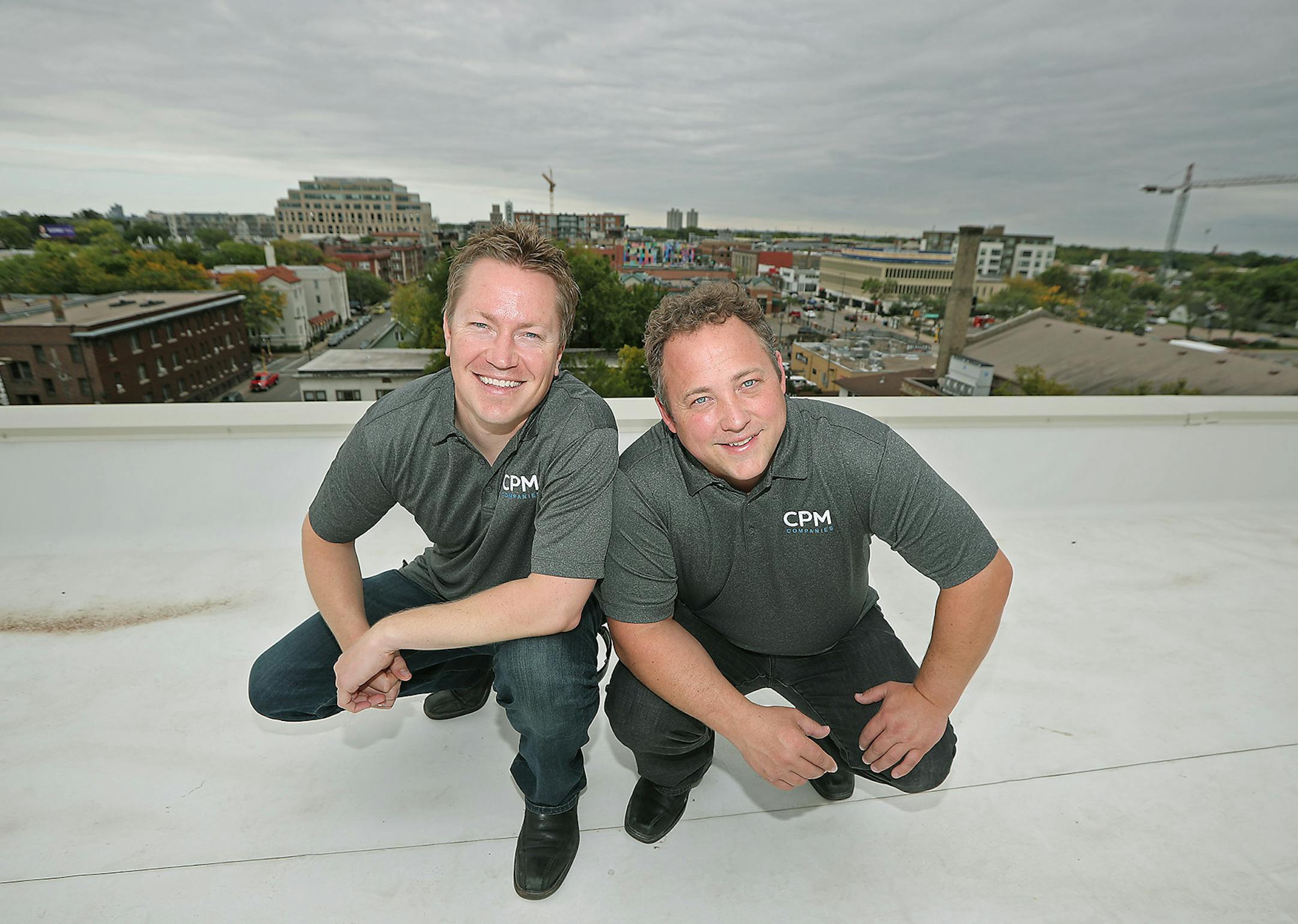 CPM Companies Nick Walton, left, and Daniel Oberpriller sat above the Uptown area on the firm's Laguna Apartments property, Friday, September 23, 2016 in Minneapolis, MN. ] (ELIZABETH FLORES/STAR TRIBUNE) ELIZABETH FLORES • eflores@startribune.com
