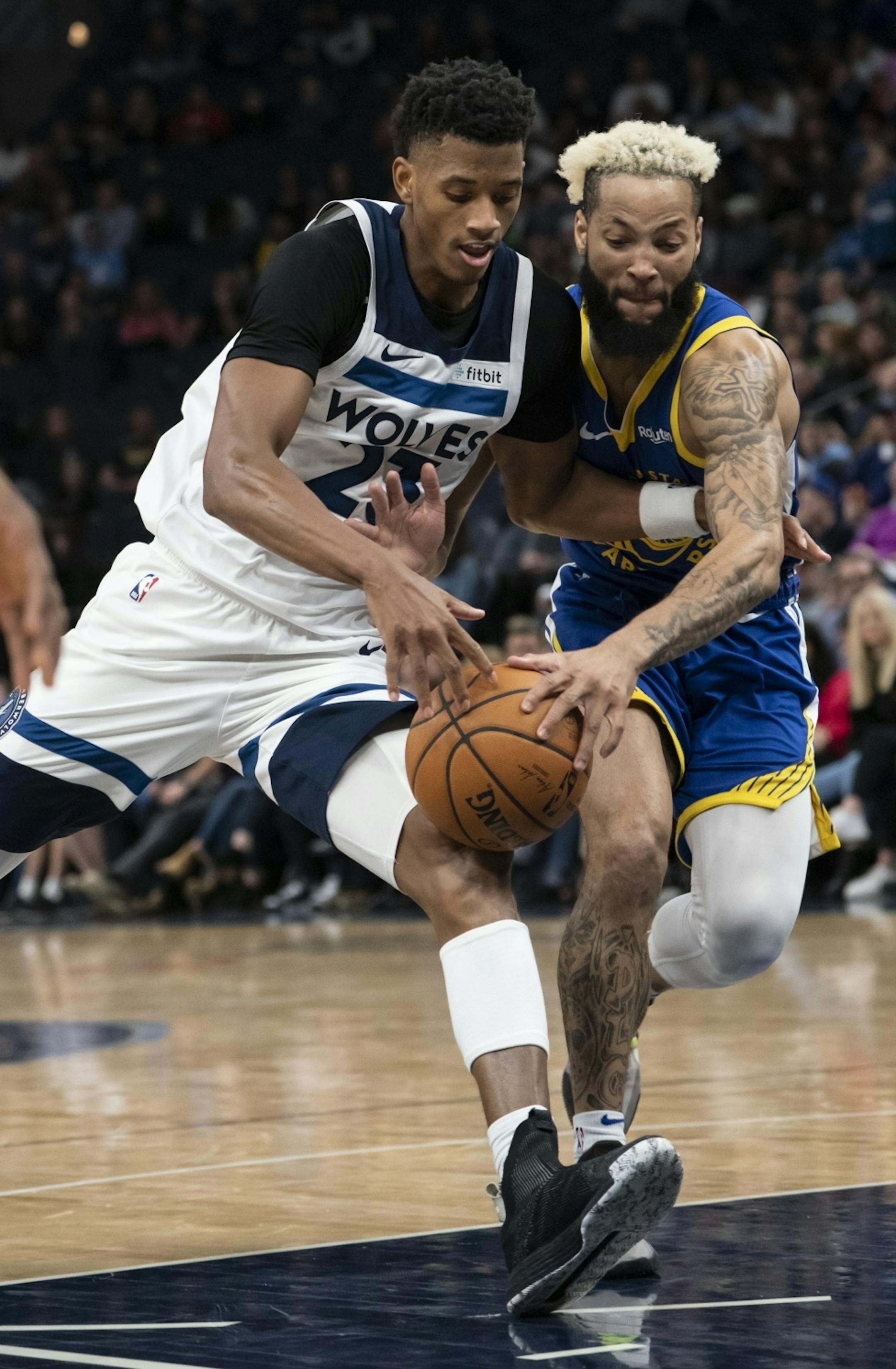 Minnesota Timberwolves guard Jarrett Culver (23) struggled for the ball with Golden State Warriors guard Ky Bowman (12) in the second half.