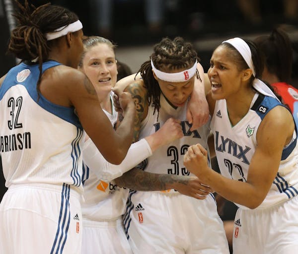 Seimone Augustus of the Minnesota Lynx is surrounded by teammates, from left, Rebekkah Brunson, Lindsay Whalen and Maya Moore during the WNBA Finals l