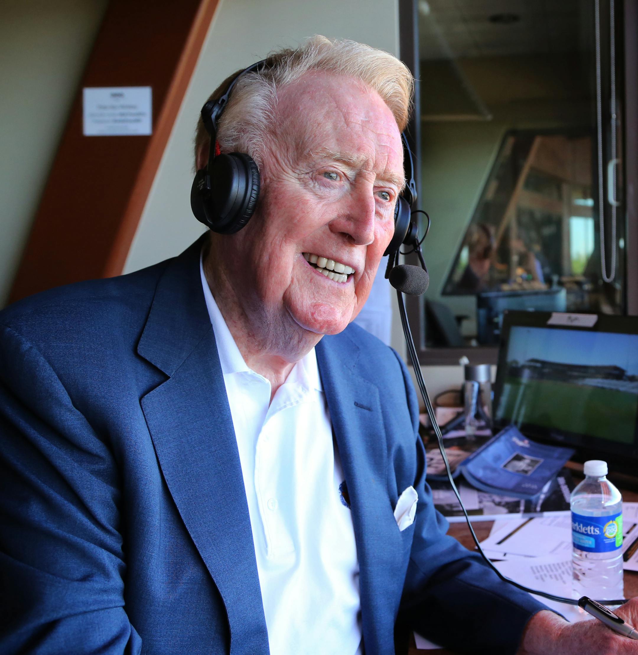 FILE - In this March 25, 2016, file photo, Los Angeles Dodgers broadcaster Vin Scully sits in the booth at the ballpark in Glendale, Ariz., for a spring training baseball game. Scully says the last ballgame he will broadcast is the Dodgers' regular-season finale--regardless of whether they reach the playoffs. (Tom Tingle/The Arizona Republic via AP)