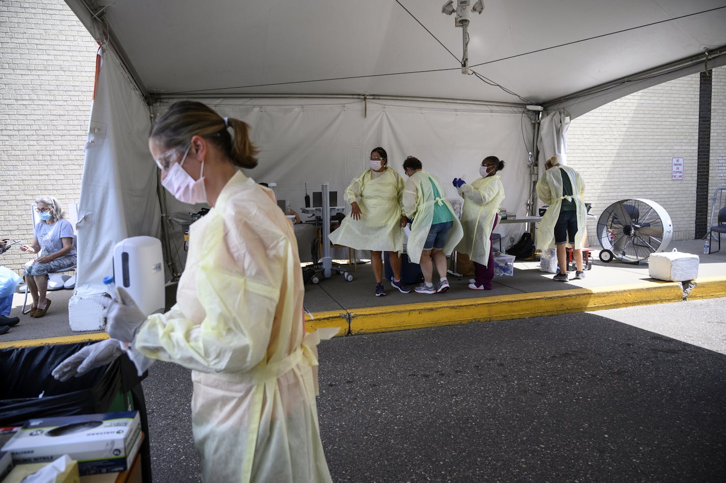 Medical workers prepared for their next COVID-19 tests last week by getting tests ready and shedding used protective gear behind North Memorial Health Specialty Center in Robbinsdale.