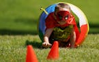 Carter Hawkins Sutton, 5, crawled through a tunnel wearing a little from Spiderman, Batman, and Superman's costumes during the Wellbeats Superhero Tra