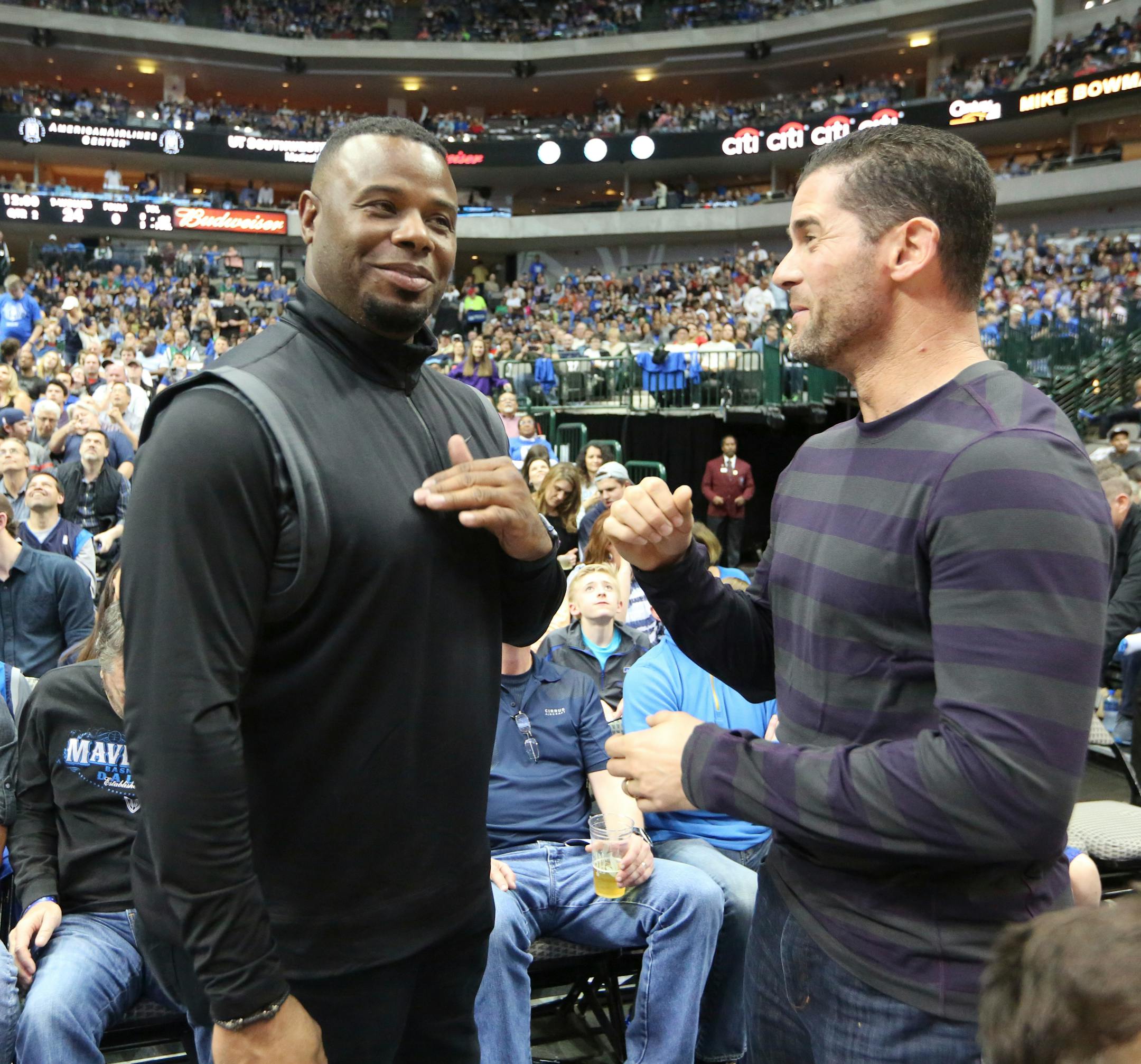 Former Major League Baseball players Ken Griffey Jr., left, and Michael Young visit during the first half of an NBA basketball game between the Minnesota Timberwolves and Dallas Mavericks on Sunday, Feb. 28, 2016, in Dallas. (AP Photo/LM Otero)