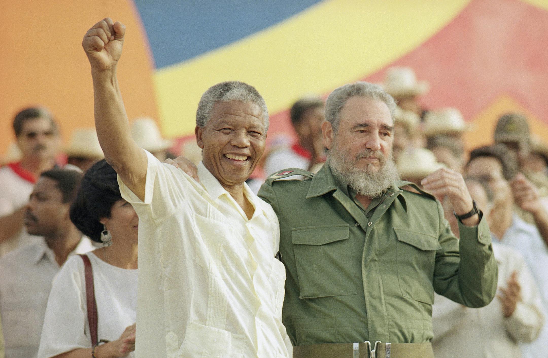 Cuban President Fidel Castro, right, and African leader Nelson Mandela gesture during the celebration of the "Day of the Revolution" in Matanzas Saturday, July 27, 1991. Cubans celebrate 38th anniversary of the revolution.(AP Photo) ORG XMIT: APHS142477