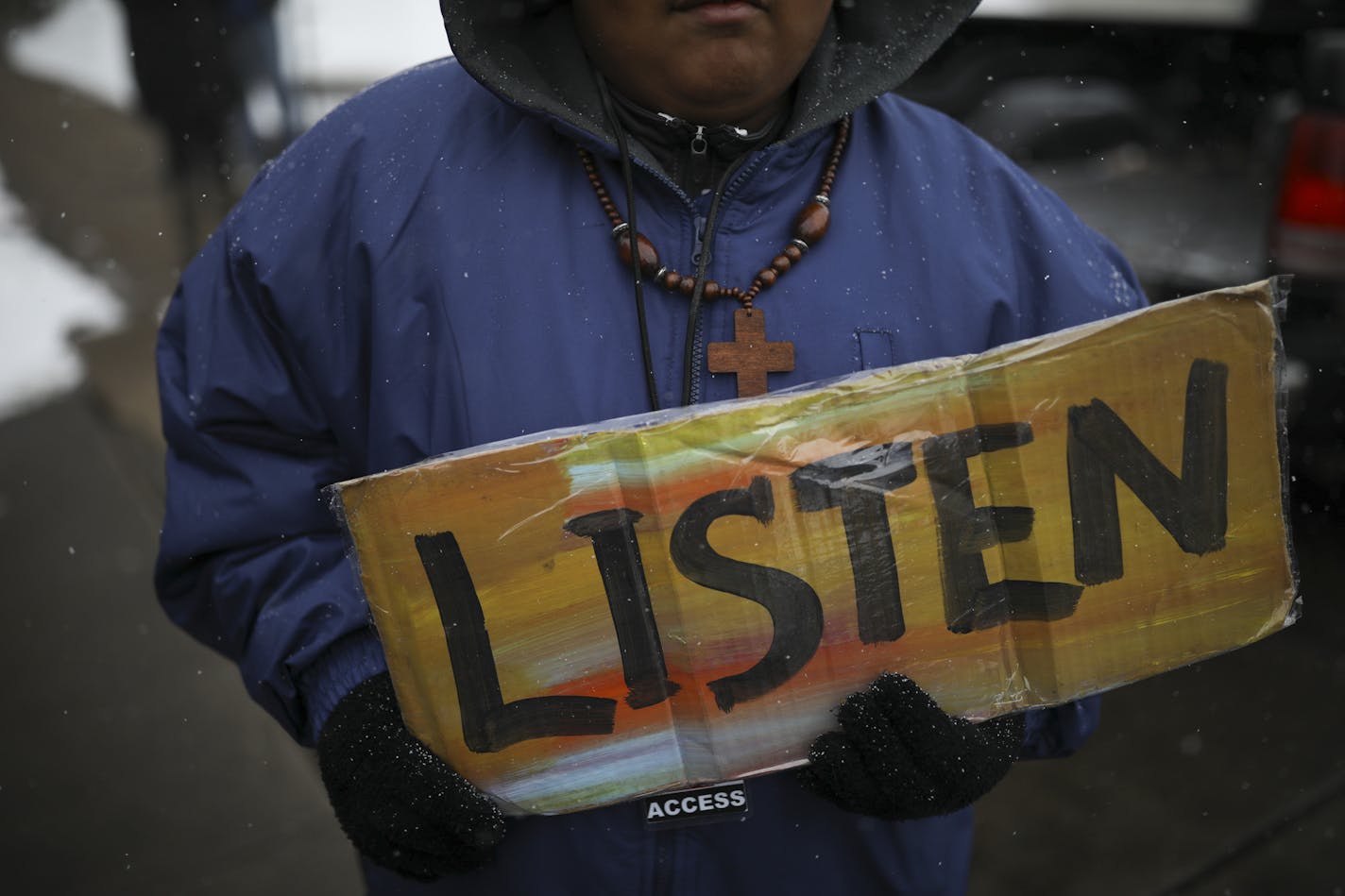 KingDemetrius Pendleton Jr. held a sign before the rally began Tuesday evening. ] JEFF WHEELER &#xef; jeff.wheeler@startribune.com A rally was held Tuesday evening, March 20, 2018 near where Justine Damond was shot in Southwest Minneapolis last July after charges were brought against the Minneapolis Police officer who shot her. Nearly 100 people stood at the corner of W. 50th St. and Washburn Ave. S. to listen to speakers talk about the events of the day.