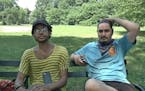 In this July 13, 2016 frame grab from video, Jordan Clark, left, and Lewis Gutierrez sit in Prospect Park as they talk about their new "Pokemon Go" bu