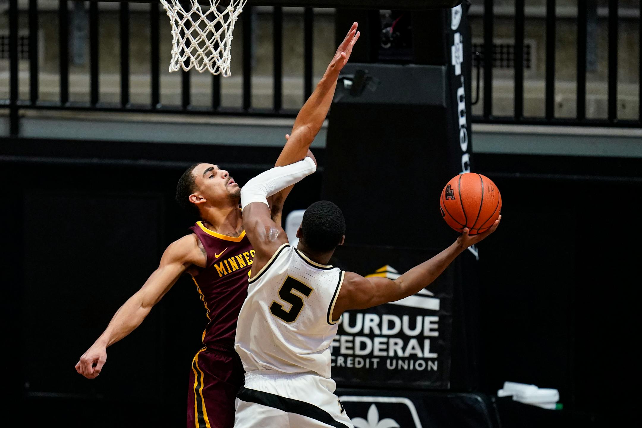 Purdue guard Brandon Newman shoots over Gophers guard Tre' Williams during the first half Saturday.