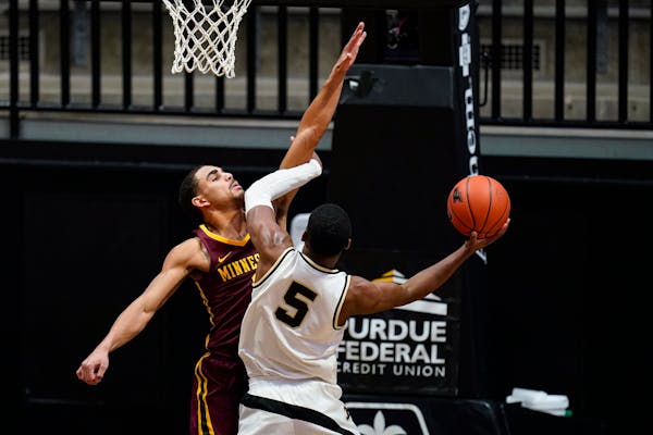 Purdue guard Brandon Newman shoots over Gophers guard Tre' Williams during the first half Saturday.